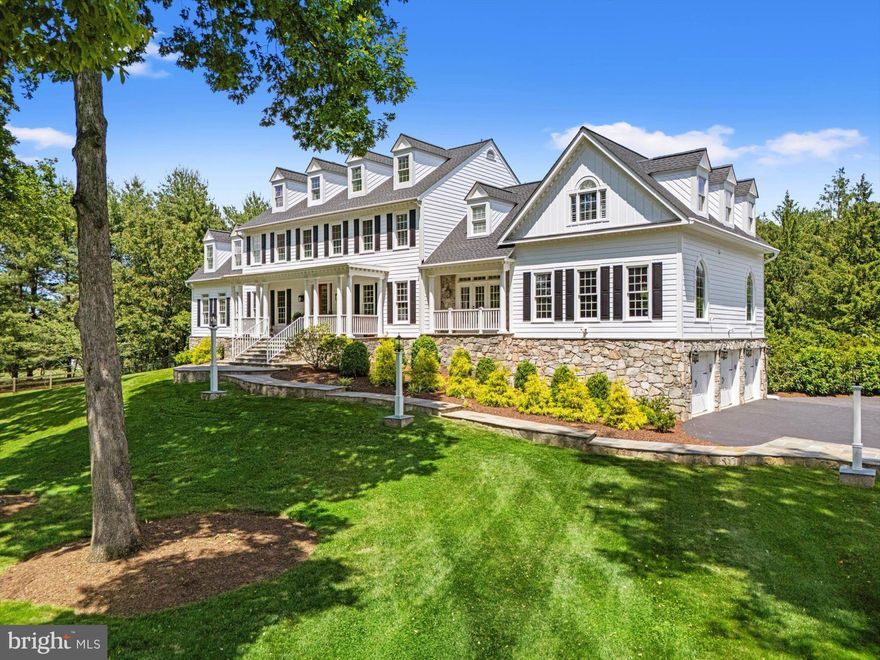 A rare opportunity in one of Great Falls’ most coveted communities! This stately Colonial farmhouse-style home sits on nearly 2 acres, framed by mature oak trees and rich landscaping. Custom-built to honor the land’s history as a former dairy farm, it blends timeless character with modern luxury across over 8,000 square feet of living space.

Designed for today’s lifestyle, the home offers grand gathering areas, formal and casual spaces, and seamless flow for entertaining inside and out. The gourmet kitchen is a chef’s dream with dual Sub-Zero refrigerators, double Bosch ovens, a Thermador gas cooktop, granite counters, and custom cabinetry. Adjacent, the inviting family room with stone fireplace opens to a bright, window-lined sunroom — perfect for a home office, playroom, or reading nook.

The home features 5 spacious bedrooms and 7 bathrooms, including two luxurious primary suites with spa baths. The larger of the two includes a private sitting area, stone fireplace, dressing room, multiple walk-in closets, and a spectacular 700 SF rooftop deck overlooking the beautifully designed backyard.

Since its last sale, the property has undergone extensive lifestyle-driven upgrades, including the addition of a luxury pool, professionally designed tennis court, and stunning new interior appointments. The fully finished walk-out lower level offers an in-law suite with private spa bath, steam, sauna, kitchenette, and laundry. A spacious rec room with wet bar, media area, gym and full windows complete the lower level.  Attic area has been finished with hardwood floors and plenty of light, perfect for an art studio, hobby/craft room, or a vibrant teen hang-out space. 

Additional highlights include four fireplaces, gorgeous hardwood floors, flagstone patios, extensive stonework, and beautifully manicured grounds.  All on public water and sewer! An extraordinary property that feels like a landmark and lives like a private resort — all within minutes of Great Falls Village, Tysons Corner, Reston Town Center, and convenient to Dulles International Airport.