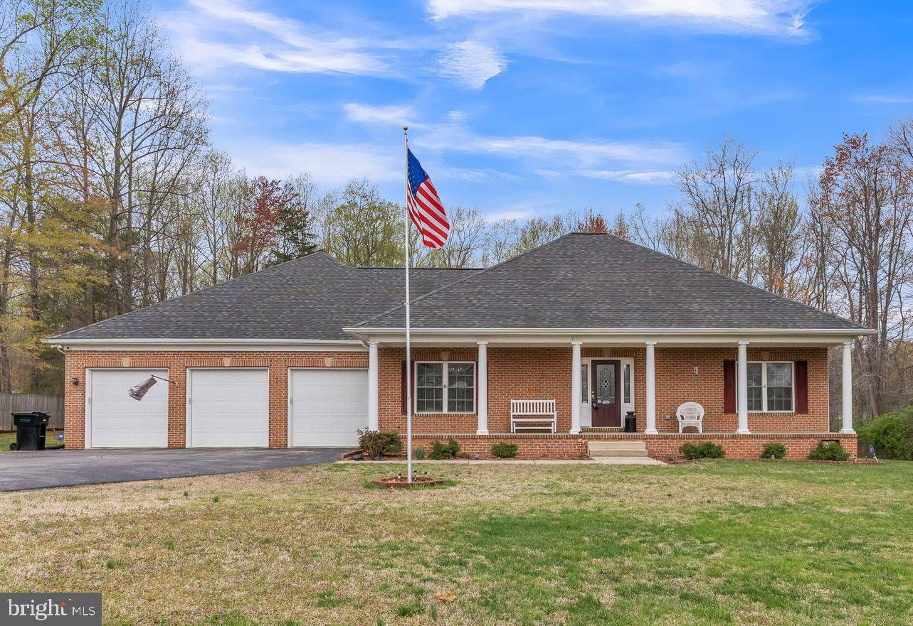 One Level Living!! Welcome home to this stunning brick front rambler on almost 2 acres that offers the perfect blend of comfort, style, and practicality. Featuring 4 nice sized bedrooms and 2.5 baths, this home is designed for easy main level living. Step inside to discover elegant hardwood flooring throughout, 9-foot ceilings that enhance the sense of space, and a beautiful kitchen complete with granite countertops, stainless steel appliances, lots of cabinet space, nice under cabinet lighting, and plenty of room to whip up culinary delights. The large master suite is a true retreat, offering privacy and luxury with ample space to unwind. You will find ceiling fans in just about every room in the home and upgraded features throughout the home. You'll be captivated by the beautiful front porch, perfect for relaxing with a morning coffee or sitting on your porch glider. If you love to entertain, you’ll enjoy the large maintenance free deck with a stunning canopy cover, ideal for entertaining or soaking in the beauty of your surroundings. For the car enthusiasts or families needing extra storage, the 3-car garage is a fantastic feature. No HOA and a convenient location providing peace, privacy, and endless possibilities.