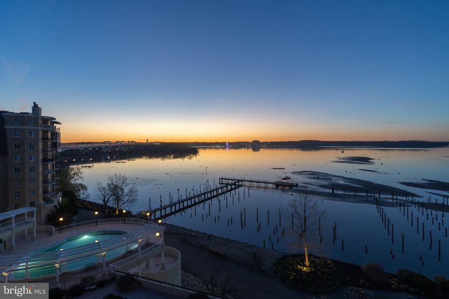 This is the Old Town water view condominium you have been waiting for!  Direct water views at Porto Vecchio in this 2 bedroom 2 bath condo with 1,697 square feet.  Awaken each day to the breathtaking views of the sun rising over the Potomac River.   Sip your cup of coffee in the sunroom and take in the views while catching up on the news, planning your day or simply marveling at the sun bouncing off the river.  Cooking in the kitchen is a breeze with Viking appliances, classic white cabinetry, quartz countertops, glass tile backsplash and roomy peninsula, plus pantry.  Entertain guests easily in the generously sized separate dining room, then enjoy after-dinner-drinks in the living room with wood-burning fireplace and built-in cabinetry.  The primary bedroom suite is outfitted with a changing area, 4 closets and upgraded primary spa like bathroom with shower and soaking tub. Second bedroom has custom built-in murphy bed with two office workspace areas.  Garage parking included - space #12.  Convenient to Reagan National Airport, Amazon's HQ2, Capitol Hill, the White House and all metro D.C. has to offer.  Don't miss the opportunity to live in Old Town Alexandria's luxury waterfront building with amenities galore including private limousine service for all residents, on-site management, elegant party rooms, newly renovated exercise rooms, excellent security and friendly community.  Outdoor activities with private tennis court, kayak dock, and outdoor pool overlooking the river. Resort living at its best!