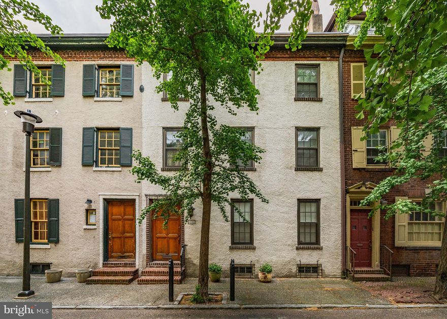 Situated on the charming block of Panama in Rittenhouse Square, this 24 ft wide home features 4 bedrooms plus a den and 2.5 bathrooms. Enter through a vestibule into the foyer. The first level floor plan has a wonderful flow from the front living room with a charming gas-burning fireplace and built-in bookshelves, into the spacious dining room with french doors to the brick patio. The kitchen is off the dining room, also with access to the patio, and features stainless appliances, stone counters and ample cabinetry. A conveniently located powder room is also on this level. A gracious staircase takes you to the second level of this home which includes a south facing primary bedroom with an en-suite bathroom complete with a seamless glass shower, dual vanity, soaking tub, linen closet and custom built-ins. The primary bedroom has direct access to the den, which features large closets and double doors to the hallway. Also on this level is the laundry closet. The 3rd level is complete with 3 additional bedrooms and a hall bathroom with a tub/shower combo and single vanity sink. A full basement offers room for storage. This home has been updated through the Sellers ownership, most recently a new HVAC system. Located in the Greenfield School district and less than 2 blocks from Rittenhouse Square Park.