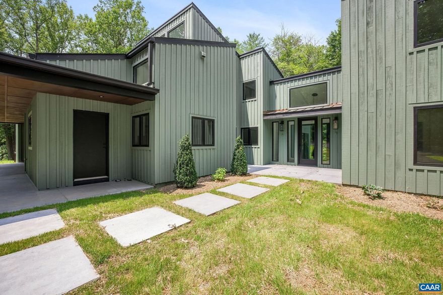 This property has undergone flawless upgrades, elevating a well-built architectural gem to a supreme level of style, comfort, and quality. Offering 5 bedrooms and soaring interior spaces, the home features two first-level primary suites, including a private guest suite. The second level includes three additional bedrooms and two baths (one en-suite), along with multiple flexible spaces ideal for creative pursuits, offices, or studios. Designed for seamless indoor-outdoor living, enjoy coffee, cocktails, or dining on four porches, including a large covered wraparound porch. The stunning new kitchen showcases premium custom cabinetry and Viking appliances, flowing effortlessly into the open great room, cozy family room, wet bar, and outdoor entertaining areas. The great room?s striking fireplace anchors the space, complemented by a second fireplace in the inviting family room. The primary suite, great room, and family room all open directly to the covered porch. A separate yet connected guest primary suite linked via a glass walkway offers exceptional privacy and includes a second-floor office or workout space. Located on 11+ acres off Garth Road surrounded by conservation land, gives it rare privacy and blue ridge view opportunity.,Quartz Counter,Wood Cabinets,Fireplace in Great Room,Fireplace in Study/Library