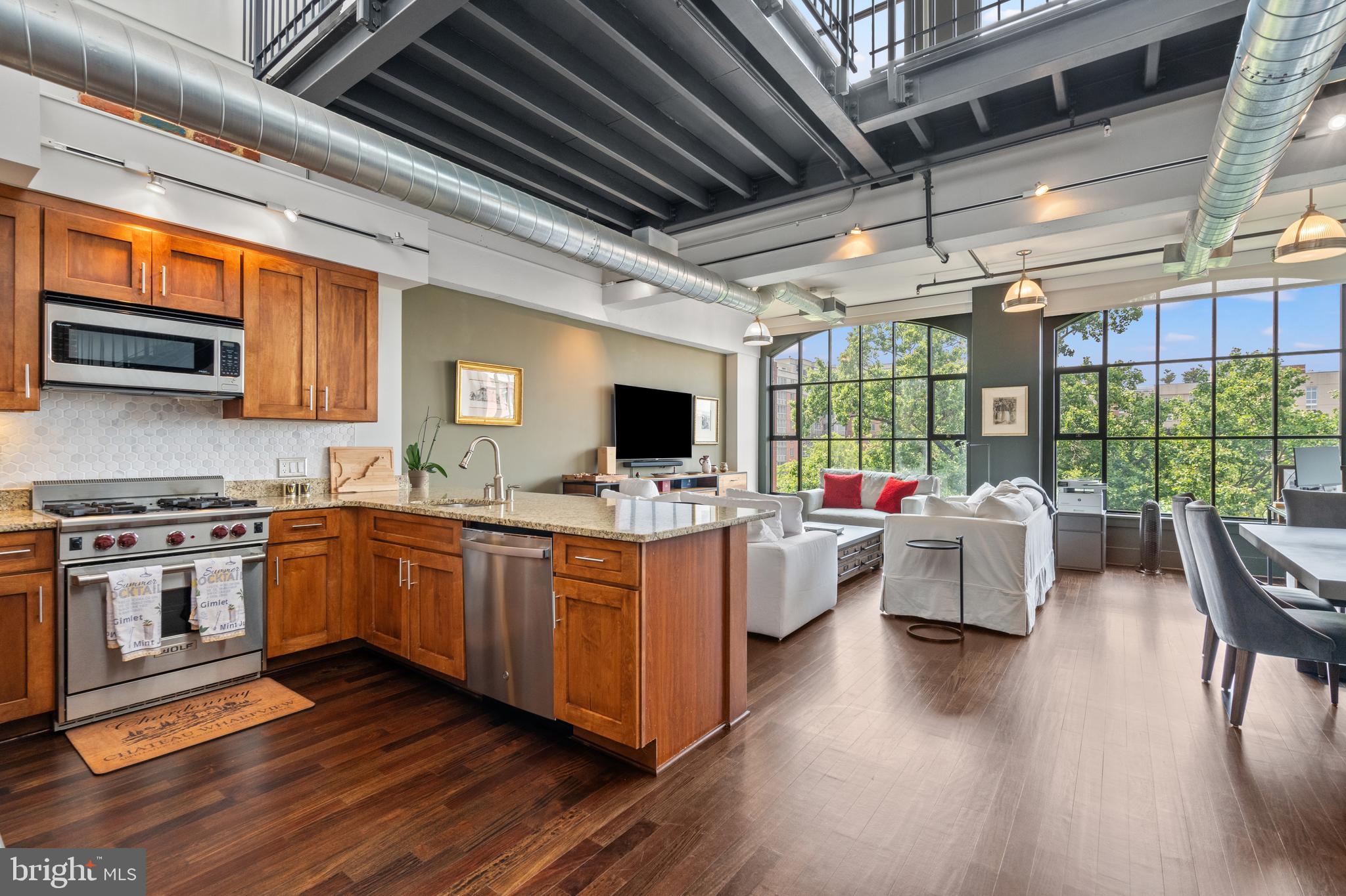 This striking penthouse loft offers dramatic 22-foot ceilings, expansive walls of glass, and a seamless blend of modern luxury and industrial design. The open floor plan includes a lofted sleeping area with direct access to a spacious private rooftop terrace spanning approximately 300 square feet—perfect for outdoor entertaining or quiet mornings in the sun. A retractable awning provides flexible shade throughout the day. Newly refinished hardwood floors add warmth and sophistication throughout the space.
The gourmet kitchen is equipped with premium Sub-Zero and Wolf appliances, custom cabinetry, and granite countertops, making it a true chef’s kitchen. The sleek, spa-like bath features elegant finishes and clean, modern lines.
Enjoy abundant storage with a large custom closet, plus the convenience of included garage parking and dedicated storage space. Floor-to-ceiling windows flood the space with southeastern light and feature remote-controlled blackout and filter shades for privacy and comfort.
Residents enjoy full access to the building’s top-tier amenities, including a fitness center, outdoor pool, and concierge services. Located just blocks from Rosslyn Metro (Orange, Silver, and Blue Lines), with quick access to Key Bridge, major commuter routes, and Reagan National Airport.
This is urban loft living at its finest.