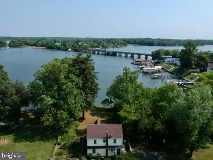 This Beautiful Waterfront Colonial Is Loaded with Character and Charm and underwent a major renovation in 2006-2007. The architectural roof, electrical upgrade, hardwood and laminate floors, gourmet kitchen, bath, fixtures and more are all from this era and look brand new. Kitchen features cinnamon maple cabinets, Corian counters, pantry with pull outs, tile backsplash, nickel fixtures and stainless steel appliances. Other features include high ceilings on main level, hardwood throughout, custom shades, ceiling fans, screened water view porch, Forced Air HVAC, partially finished basement with slate floors, mature landscaping, community beach, boat ramp, picnic area and playground access w/ optional $100/year fee. 
There is a waterfront lot in front of home owned by someone else with no access according to county. County calls this home waterfront but it is water view. Call for details. Hurry, this home will not last!