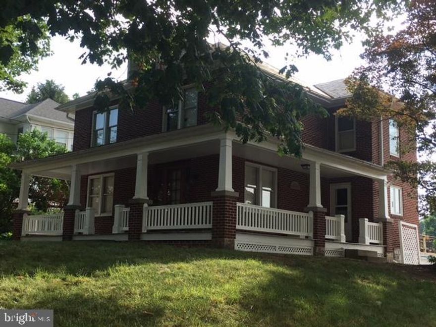 Stately brick 2 1/2 story, 4 bedroom, 1 1/2 bath corner lot home is a must see.  Imagine your summer nights relaxing on the covered wrap around porch or beautiful concrete patio overlooking the large back yard.  Inside you will find an expansive eat-in kitchen, first floor laundry with 1/2 bath, welcoming foyer and dining room with beautiful pocket doors.  Storage will never be a problem with a full attic, storage shed, 2-car garage plus storage and a basement workshop.  1-year Home Warranty for buyer.