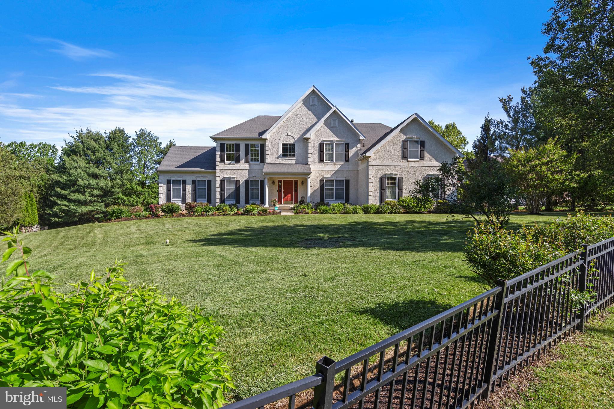 2063 White Horse Road, corner of White Horse and Pebble Springs is a beautifully updated 5-bedroom, 4.5-bath home in the desirable Berwyn Estates neighborhood, within the top-ranked Tredyffrin-Easttown School District. Positioned on a scenic .84-acre corner lot with black wrought iron fencing and flowering landscaping, the property offers expansive living across three finished levels—including an exceptional walkout lower level. Set along picturesque White Horse Road, the home offers excellent curb appeal and thoughtful enhancements throughout. Recent improvements include fresh interior paint across most of the home, wide-width bamboo flooring on much of the main level, new carpeting upstairs, luxury vinyl plank flooring in the lower level, and updated light fixtures in select areas—creating a bright and welcoming environment.
Inside, the foyer makes a strong first impression with a sweeping staircase and natural light that floods the main level. Formal living and dining rooms flank the entry, both with detailed dental crown molding. The living room flows into a tiled sunroom with high ceilings and three walls of windows, ideal for morning coffee or evening relaxation. A powder room is tucked off the foyer.
The great room is a showstopper with vaulted ceilings, a gas fireplace, and windows on three sides that bring in beautiful light and views. It opens to the breakfast room, where skylights and a glass door create an airy connection to the deck and backyard. The adjoining kitchen is designed for both entertaining and daily living, with a granite island that seats four, stainless steel appliances, classic cabinetry, and abundant storage. Just off the great room, French doors open to a private office with a wall of custom built-ins—perfect for working from home or quiet study. A rear staircase, mudroom, laundry room, and 3-car garage access round out this functional main level.
Upstairs, the newly carpeted primary suite begins with a sunny sitting room that leads to the spacious bedroom. A large walk-in closet with natural light and hanging space on both sides provides excellent storage. The en-suite bath features a dual-sink vanity, soaking tub, tiled floors, and a separate stall shower. Bedroom 2 also has new carpet and an en-suite bath. Bedrooms 3 and 4, with hardwood floors, share a Jack and Jill bath with dual vanities. The thoughtful layout supports comfort and privacy for everyone.
The expansive walkout lower level has been transformed into true living space, with newly installed LPV flooring, high ceilings, recessed lighting, and deep-silled windows. Trimmed with beadboard wainscoting and freshly painted, this level includes a large family room with gas fireplace and custom built-ins, a recreation area currently showcasing an Olhausen pool table, built-in cabinetry, and a 5th bedroom with glass-paned doors, walk-in closet, and full ensuite bath—offering flexibility for guests or an Au-Pair. Two storage rooms complete this level.
Outside, the raised rear deck overlooks a flat backyard and side yard, offering space for play, entertaining, or gardening. The home sits on a quiet corner lot with ample driveway parking and convenient side-street access.
Located just minutes from top-ranked Tredyffrin-Easttown schools—including Beaumont Elementary (less than a mile away)—and many private schools, including Episcopal Academy (.7 miles). The Paoli R5 train to Philadelphia and NYC (1.2 miles) is nearby, as are Main Line destinations such as Berwyn, Devon, Paoli, Wayne, and Newtown Square. Enjoy easy access to local dining, boutique shopping, golf courses, and country clubs—with King of Prussia Mall also just a short drive away.
Thoughtfully designed and beautifully maintained, this home offers a rare blend of space, style, and location in one of the Main Line’s most desirable neighborhoods. Driveway could be added to Pebble Springs with township approval.