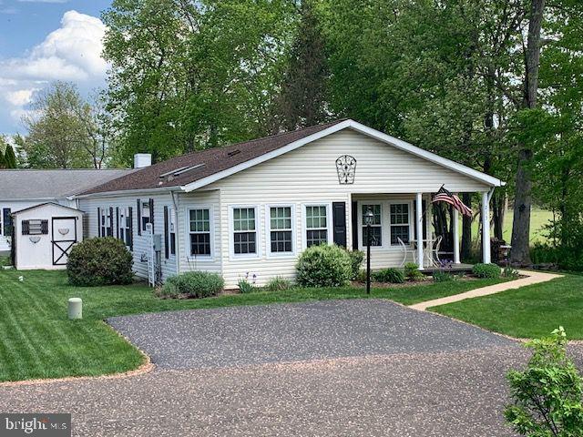 You found the ONE!! Beautifully situated at the end of a peaceful street in The Village of Buckingham Springs! Enjoy being able to just move in and enjoy this home! All the hard work has been done!Extra wide driveway leads to the sweet front porch at the front door. Foyer entry with large closet leads to expansive living room with lots of windows, and wood-burning fireplace with mantle. Doorways open to the charming large breakfast room, continues to the updated kitchen with all newer appliances in the past 4 years. Dining room open to living room for easy entertaining. Hot water heater has also been replaced. Laundry room has extra folding space and great storage, and an exit door to the beautiful rebuilt deck with wrought iron railing, all facing woodsy space and also has an electric awning. Sweet space to unwind! The two bedrooms are spacious, and Main BR has a huge walk in closet as well as another one in the room. Main Bath has a soaking garden tub, charming newer sink with a "furniture" cabinet, separate shower area.
Hall Bath has also been redone with beautiful tiled shower, and updated appliances. Soft paint colors throughout, and entire house has bamboo laminate flooring. Nothing to do but to move in and enjoy life!!