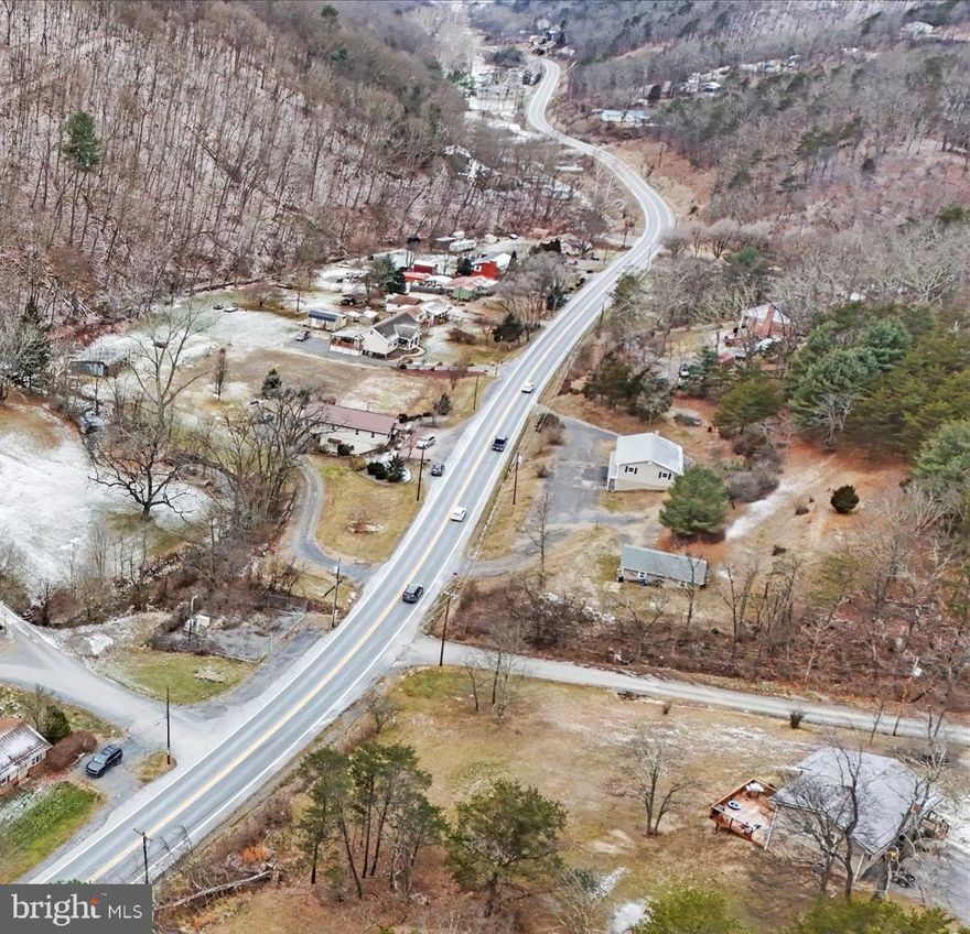 Versatile Income-Producing Property on Over 2 Acres – Unrestricted & Multi-Lot Opportunity

This exceptional residential property offers a rare blend of immediate income, flexibility, and future development potential. Situated on three unrestricted lots totaling just over 2 acres, the property features a two-unit residence ideal for investors, multi-generational living, or owner-occupants seeking rental income.

The upper apartment includes 3 bedrooms and 2 full bathrooms, while the lower apartment offers 2 bedrooms and 1.5 bathrooms. Each unit is equipped with separate water and electric meters, providing efficiency and ease of management. A new metal roof installed in 2015 adds long-term durability and peace of mind.  

Previously utilized as a landscape supply yard, the property includes a heavy-duty gravel lot rated for tractor trailers and dump truck deliveries, offering exceptional parking and commercial-grade utility. An equipment building is already serviced with electric and water, with interior outlets in place—ideal for storage, workshop use, or future expansion.

Outdoor living is elevated with a large wood-burning fireplace patio, complemented by an adjacent elevated patio perfect for grilling or a future outdoor kitchen. Mountain views and a natural stream running through the property create a peaceful setting while enhancing tenant appeal and long-term rental value.

Located in a high-demand market with proven rental performance, this property supports long-term rentals, short-term rentals, or conversion back to a single-family residence. The unrestricted zoning and multiple lots provide numerous opportunities for future development, expansion, or resale.  Adding to the property’s upside, the current owner previously received county approval of a preliminary plan to add multiple rental cabins, highlighting the site’s strong development potential

A truly rare offering combining income generation, unrestricted land, ample parking, and scenic surroundings in a sought-after location that's close to schools, shopping, dining and many area recreational landmarks.