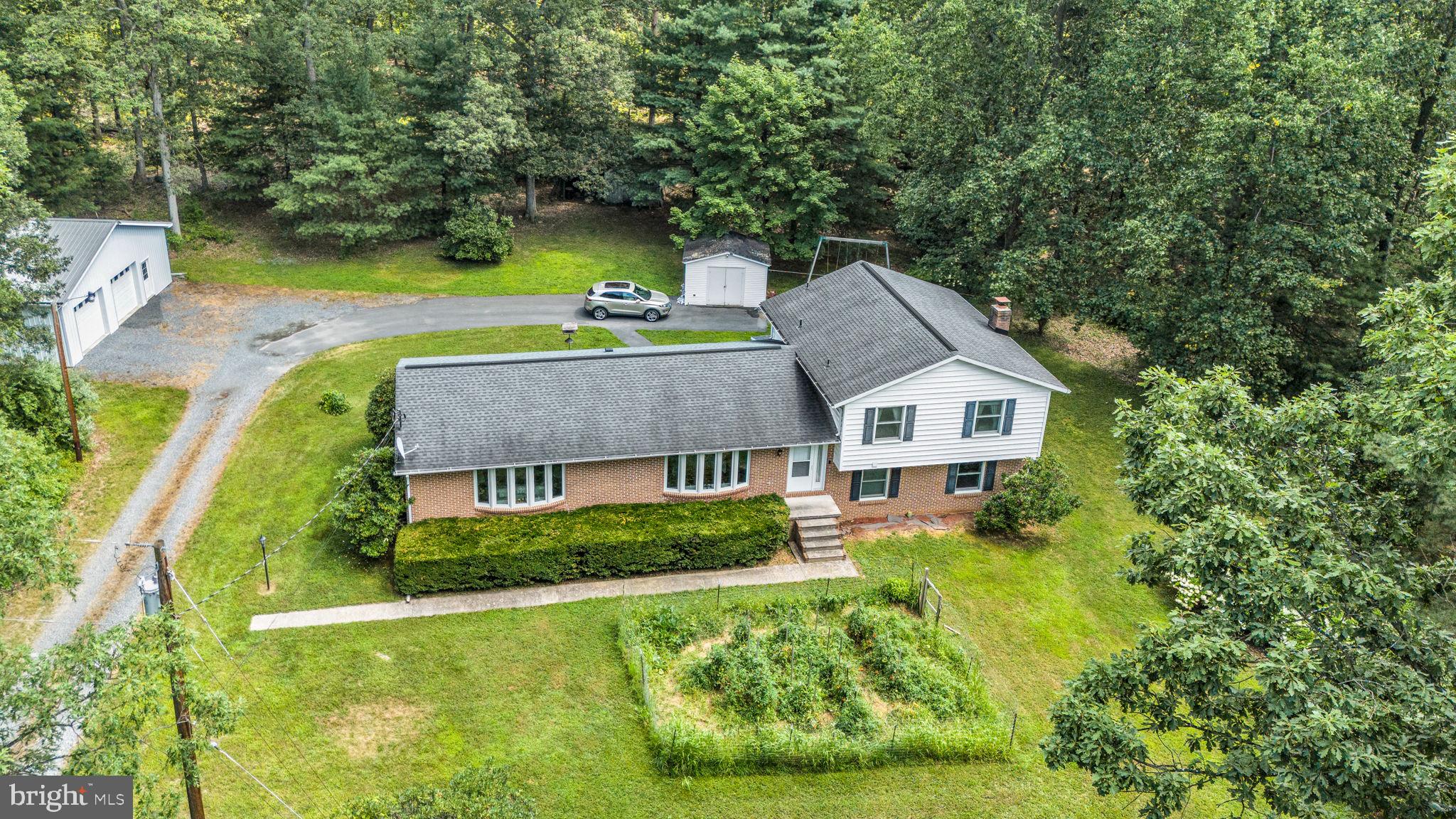 Secluded Serenity Meets Modern Comfort – Beautiful 3-Bedroom Home on Expansive Wooded Lot
Tucked away on a peaceful lot, this beautifully maintained 3-bedroom, 2.5-bath home offers the perfect balance of privacy, space, and modern updates. From the moment you arrive, the natural beauty of the large, wooded setting welcomes you, creating a tranquil retreat just minutes from everyday conveniences.
Step inside to discover a thoughtfully designed interior for both comfortable living and stylish entertaining. At the heart of the home, the renovated kitchen features sleek countertops, stainless steel appliances, custom cabinetry, and a spacious layout that flows effortlessly into the dining area—ideal for hosting gatherings or enjoying quiet meals at home. The living room is flooded with natural light, enhanced by expansive windows that frame picturesque views of the surrounding trees. Upstairs, the primary suite offers a peaceful escape with ample closet space and a private en-suite bath, while two additional bedrooms provide flexibility for family, guests, or a home office. A convenient half bath on lower level and an second full bathroom upstairs ensure both function and comfort.Bonus additional lower level family room with cozy fireplace adds warmth and charm, making it a favorite spot year-round. Outdoors, enjoy your own private oasis: the generously sized lot offers endless possibilities for gardening, recreation, or simply relaxing under the canopy of mature trees. The oversized garage is another standout feature—perfect for hobbyists, extra storage, or even a workshop. With ample driveway space and a smart layout, this property offers both practicality and peace of mind. This is more than just a home—it’s a lifestyle surrounded by nature, yet close to shopping, dining, and excellent schools.
