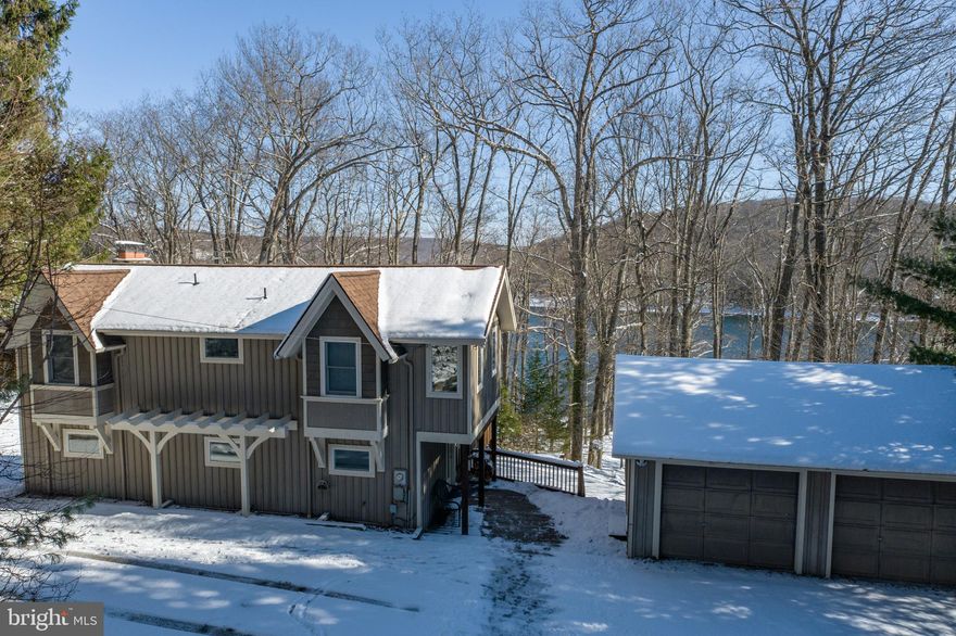 Charming Lakefront Cottage on Deep Creek Lake – Located on Shingle Camp Rd, this 4Bed 3Bath lakeside home features a wide-open floor plan, two wood-burning fireplaces, a detached two story 2-Car Garage, and beautiful views of Deep Creek Lake! Modern Kitchen with eat-in island bar seating and additional dining room. Vaulted ceilings in the great room with an abundance of natural light. Large second story back deck and lower-level patio offer loads of outdoor living space. Additional family room downstairs in the walkout basement provides additional space for game room and wet bar - perfect for entertaining. Sold fully furnished with Hot Tub & Private Type A dock included. Located just minutes from local establishments, state parks and Wisp Resort, this endearing lakefront bungalow is the perfect home to start enjoying everything the area has to offer.  Call today for details!