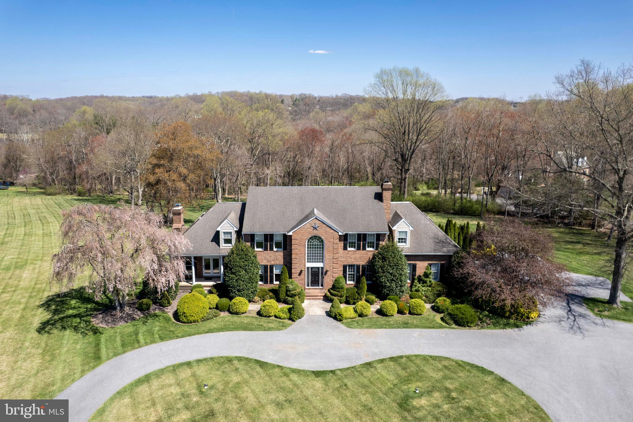 *Welcome to this exquisite 5BR, 3.5BA custom Colonial on over 3+ beautiful acres*Exterior highlights include a stately brick entrance, circular driveway, oversized parking area, 2-car attached garage, classic columned front porch, professional landscaping, "ninja warrior" style exercise area, and a covered cabana with built-in grille, countertop, and sink*Enjoy outdoor living on three maintenance free decks overlooking a lush, private backyard*Inside, the main level features a grand 2-story foyer with marble floors, formal dining room, custom moldings, living room with wood-burning fireplace, and a spacious country kitchen with stainless appliances, center island, and sunny breakfast room*A large, light-filled family room with a grand gas fireplace opens to the luxurious front porch and rear decks*The main-level laundry has granite counters and newer washer/dryer*Upstairs, the luxurious owner’s suite offers vaulted ceilings, skylights, private balcony, large walk-in closet, and a spa-like bath with double sinks, soaking tub, walk-in tiled shower, heated tile floor, and ample cabinetry*Additional rooms include a library, two standard bedrooms, and a custom vaulted bedroom with built-ins*The fully finished lower level offers in-law or multi-family options with a full kitchen, dining area, rec room, 5th bedroom, bonus room, and two storage rooms—plus walkout access to the rear deck*Located in the Sandymount, Shiloh, and Westminster High school zones*No HOA*No city taxes*Ample parking space for your RV or guests*A rare blend of elegance, comfort, and versatility*