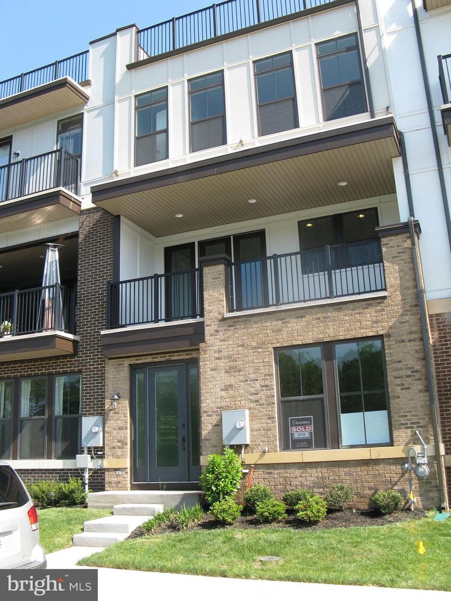 Newer Van Metre brick front home featuring 3,100 square feet on 4 levels, and located in the beautiful community of Brambleton.  The home is in the Madison Trust Elementary Schools pyramid.  Let me describe some of the main features of this home.  The entry level has a  bedroom and  a full bathroom.  Also, there is an attached 2 car garage with a separate rear back entrance with additional parking in the front of the home.  The next level has an large open floor plan which includes a gourmet eat in kitchen area with 42" cabinets, granite counters,  stainless steel appliances, with an isalnd.  There is a front deck off the kitchen where you can relax enjoing the nearby views. The remaining inside  space is for dining  and use as a family area, relaxing around a gas fireplace.  The entire level has beautiful engineered hardwood floors.  An additional balcony is features off the family room.  The third level has 3 generous bedrooms, with walk-in closets, ceiling fans, and 2 deluxe bathrooms with granite counters, with tubs and/or glass enclosed showers.  A washer/dryer is included on this level.  The fourth level includes an inside mini wet bar convenient to the roof-top terrace.  You can enjoy the privacy of sunbathing by day or an evening dining under the stars with family or friends.  Water and natural gas is available for your use on the roof-top.  

You can walk, jog, bike, or drive a short distance to the Brambleton Town Center.  The Brambleton community has many amenites, including over 250 acres of green space,  over 18 miles of paved walking trails, 4 community pools, parks, tennis, and basketball courts and over 40 dining, shopping, service and entertainment options, including a movie theatre, gym, and library.   The home is just minutes to Dulles Airport, Dulles Greenway, and one of the two new Ashburn Metro stations.