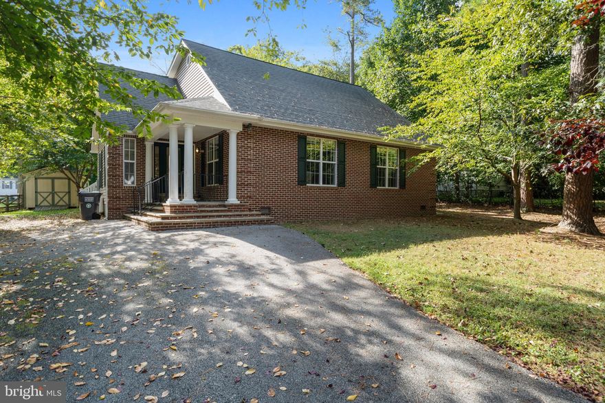This custom-built brick colonial sits in a great neighborhood on the edge of  the Patuxent River. The nearly half-acre lot feels very private, as the house is surrounded by towering trees. 

Inside, the 4-bedroom home even has room to grow, as the loft space has been roughed in to accommodate a third full bathroom. 

The open-concept main level includes hardwood floors, soaring ceilings, a cool spiral staircase and big windows that lets in lots of natural light. 

The timeless kitchen is open to the living room and features stainless steel appliances, a tile backsplash, 42-inch cabinetry, stone countertops and a center island. Through the French doors, you’ll find a back deck with plenty of space to entertain. The backyard also includes a storage shed, while the extra-wide driveway offers a spot to store your RV or boat. 

Back inside, the primary bedroom boasts an updated ensuite with a step-in shower and lots of storage. The guest rooms share the full hallway bathroom. At the top of the spiral stairs, the loft area could become an in-law suite, home theater or office. 

Golden Beach is a quiet waterfront community with a playground, and residents can use the neighborhood boat ramp or fish from the dock.