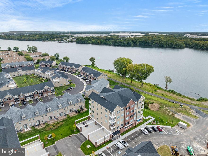 Welcome to 16442 River View Drive in the desirable Radcliffe Courts community of Bristol, PA — a stunning LIKE NEW construction condo (only 8 months old) that offers the perfect blend of modern design, low-maintenance living, and a prime location along the Delaware River. Why wait for new construction when you can move right into this nearly new home? Step inside to find a bright and open floor plan with high ceilings, recessed lighting, and luxury finishes throughout. The gourmet kitchen is the heart of the home, featuring 42" cabinetry, quartz countertops, a peninsula island with seating, stainless steel appliances, and a stylish tile backsplash. The kitchen flows seamlessly into the dining area and spacious living room, making it ideal for both entertaining and everyday living. You also have beautiful views of the Delaware River from your kitchen. This condo offers 2 spacious bedrooms and 2 full bathrooms, including a private primary suite with a walk-in closet and a spa-like bath boasting dual sinks and a glass-enclosed shower. The second bedroom is perfect for guests, a home office, or flex space. Enjoy morning coffee or evening sunsets on your private balcony with scenic river views, adding a serene touch to your daily routine. Additional highlights include in-unit laundry, ample closet space, energy-efficient systems, and reserved parking in a covered parking garage underneath your condo. The elevator also adds to the convenience of simplified living. Radcliffe Courts is a beautifully designed community with easy access to the Bristol waterfront (just a short 15 minute walk or 2 minute drive), local shops and dining, and major commuter routes. With its modern style and unbeatable location, this condo offers the best of Bucks County living with none of the wait... and the most affordable condo on the market in Radcliffe Courts. Don’t miss your opportunity to own this like-new home at 16442 River View Drive. Schedule your private tour today!