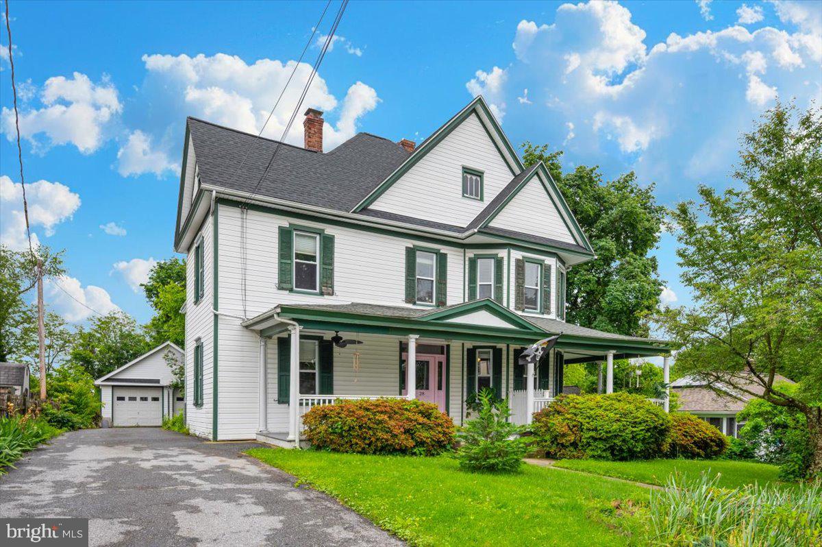 Big, beautiful Victorian home with bedrooms and baths on both levels! In the county town of Thurmont, nestled in the Catoctin Mountains. Pulling into the drive, you will see a beautiful Cherry tree and large wrap-around porch. It is a perfect spot for front-porch sitting! The front door leads to a center hall and impressive stairway. The traditional layout on the main level features a large living room, large dining room, and updated kitchen. Off the hall is a bedroom (great for home office) and full bath (and laundry). Tucked behind the kitchen is another full bath, bedroom (with private exterior entrance!), and mud room leading to the rear yard. The basement is accessed off the corner of the kitchen. Upstairs are five additional bedrooms and a third full bath. Note the wood floors and mouldings throughout. The rear yard is fenced. It also has a patio, pergola, perennial plantings, and even a vegetable garden bed. The 3+ car garage is detached. This home offers lots of space, inside and out! Thurmont offers small-town charm with restaurants, parks, schools, and other amenities. Close access to major roadways too!