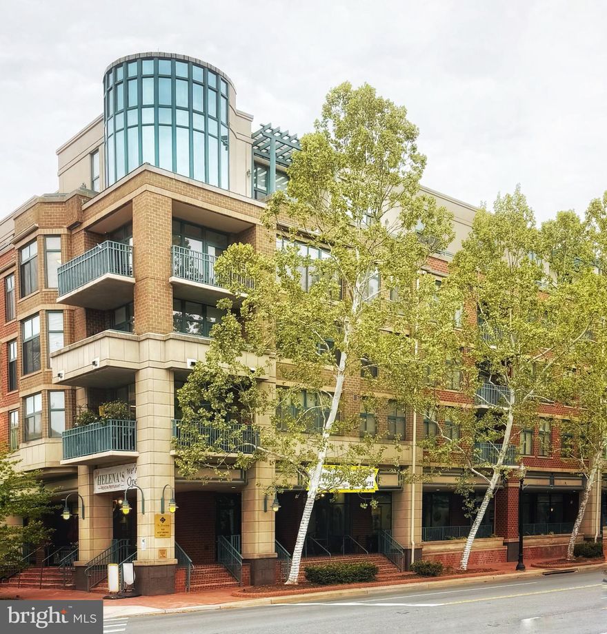 Nestled in the heart of Falls Church City, this charming 2-bedroom, 2-bathroom mid-rise apartment offers a perfect blend of comfort and modern living. This traditional-style unit has thoughtfully designed space, featuring warm wood floors and an inviting layout that seamlessly connects the dining and living areas. The gourmet kitchen is a culinary enthusiast's dream, equipped with a built-in microwave, dishwasher, and ample pantry space, making meal prep a delight. Relax in the spacious living room, complete with an electric fireplace, perfect for cozy evenings. The adjoining dining room has a lovely balcony overlooking the interior courtyard. The primary suite features a luxurious soaking tub and a walk-in shower. Custom built-ins and a generous walk-in closet take care of all your storage needs in addition to secured garage level storage. Enjoy the convenience of in-unit laundry with both washer and dryer included, and take advantage of the building's amenities, including an exercise room, library, and party room for gatherings. With two dedicated garage parking spaces, your daily commute is a breeze, especially with two metro stations and a bus stop just a short walk away. Located less than 10 miles from the airport and surrounded by local shops, dining, and parks, this home is not just a place to live, but a lifestyle to embrace. Experience the warmth and community spirit of The Broadway Condominium-your new sanctuary awaits!