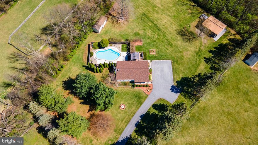 Do you have peace and tranquility on your mind? Then look no further, this stunning Ranch Home sitting on just about 2 Acres in Westminster MD close to the MD/PA line is now available! Offering 3 bedrooms, 2 full bathrooms, & a fully finished basement to host your family gatherings or cozy up by the soap stone wood burning stove! The kitchen has marbled black granite counter tops, tile backsplash, double oven, breakfast bar, & double door leading out to the maintenance free deck overlooking the pool and yard!  With summer right around the corner you're going to LOVE dipping into your own private In ground swimming pool and barbequing on the deck or patio! The oversized heated garage has plenty of room for any handyman or car enthusiast with a ramp/ lift, workbench, & air compressor! This home has been VERY well maintained. The pool has been redone in 2023, Newer Roof in 2022, replacement windows within the last 10 years, paved driveway & fresh carpet throughout the finished lower level! This home is a one stop shop! You must check it out!