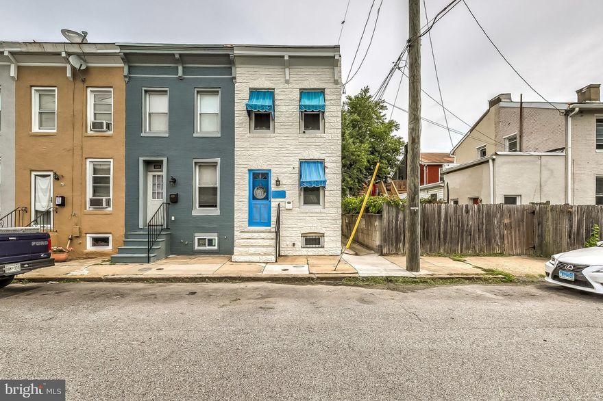 Beautifully maintained end unit in sought after Hampden! Take a short walk to dining and entertainment on The Avenue. This home features a true dining and living room with a ton of charm. Kitchen includes gas cooking and spacious white cabinets with gleaming hardwood floors throughout the home. Updates include: baths, recessed lighting, enclosed deck with a freshly painted pop of color for a beach feel. Custom awnings and tinted windows installed for energy efficiency.  Laundry room and full bath on main level. Relax on the deck with private, fully fenced backyard and your own parking pad!