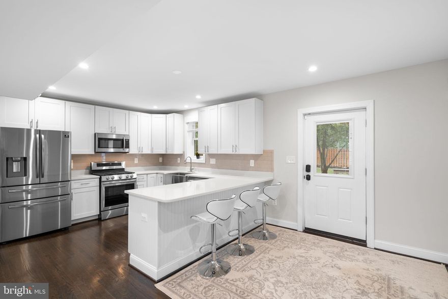 Now Presenting this meticulously maintained and fully renovated 3 Bedroom + Den / Bonus Room, 3 Bathroom Brickfront Detached Home with rare for the area 1 car garage and driveway in North Arlington that is 1/2 mile to Ballston Mall and Metro! Upon entry, you are met by pristine walnut hardwood flooring throughout main level, open concept floorplan with living and dining areas that are both adjacent to the gourmet kitchen with quartz counters, white shaker cabinets, stainless appliances and custom subway tile backsplash. Off the kitchen is access to exterior living space that includes large deck for entertaining and fenced, large completely flat back yard. Upstairs are three generously sized bedrooms and fourth bonus room / den, all with walnut hardwoods, including primary bedroom with en-suite renovated full bathroom with stand-in shower that includes tile and floor to ceiling glass door.  Second and third bedrooms share second full bathroom upstairs with soaking tub and shower combo. Finished walk-up recreation basement level with pristine laminate flooring, laundry and third full bathroom. This home is in a perfect location nearby restaurants, coffee and retail in North Arlington, including all Ballston Quarter has to offer. It resides in the Ashlawn / Swanson / Washington-Liberty School District and is  close to Route 66, 50 and DCA for commuting purposes. This property is a commuters dream and is in beautiful condition on a flat usable lot, do not miss it! Available 11/7/25