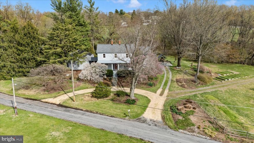 OPEN HOUSE SATURDAY APRIL 4th from 12 -  2 pm.  2.44+/- acres with a charming home, stunning gardens, multiple outbuildings, and a special exception for a nursery/greenhouse. THE HOUSE has an inviting floor plan with a  large mudroom, updated kitchen with high efficiency soapstone masonry heater and bake oven,  spacious living room, quiet home office, and plenty of living space on the second level with a large primary bedroom. The historic house also has modern insulation, energy efficient windows, recently replaced roof, high efficiency furnace, two wood stoves, custom built-in cabinetry, and added storage closets. Back patio with oven is great for entertaining! THE BACKYARD enjoys a peaceful stream, mature gardens and trees, grass yard area, large patio, and backs to a forest! The grounds really set this property apart, cut your own dazzling bouquets right from the backyard.  SOLAR PANELS on garage/shop keep electric bills to a minimum (owned, not leased!!). OUTBUILDINGS FOR HOBBIES AND STORAGE - expansive 4 bay garage/shop, two bay pole building, and a stable.  SPECIAL EXCEPTION FOR HORTICULTURAL NURSERY AND GREENHOUSE-  Property features a separate entrance for the nursery area, shade house and water lines in the existing nursery/business area. Road frontage on State Route 28 provides a premium location for signage. COMMUTER FRIENDLY -One block from the Marc Train station with passenger service to DC Metro, Silver Spring,  Union Station, etc... and State Route 28 provides easy access to Frederick, Rockville, and DC. C&O Canal and Monocacy River boat ramp are around the corner and Sugarloaf mountain and wineries are a quick drive. In the top rated Poolesville School Cluster. Contact listing agent for details and to schedule a private tour today.