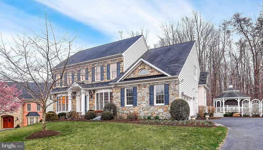 Major Price Adjustment! Stunning, stone-front Colonial, boasts pristine & sun-bathed interiors! Architectural features include open layout, opulent windows, elaborate molding, hdwd floors & 11 ft ceilings! Gourmet kit hosts Jenn-Air wall ovens & cooktop, 42 inch cabs, granite & other amenities. Plus, main lvl master w/ 2 custom WIC & lux bath, newly built rec rm w/ walk-out, & spacious upper lvl!