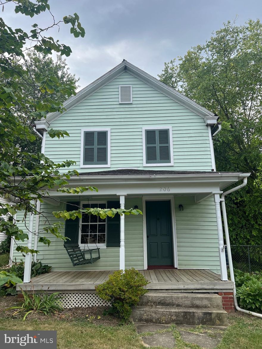 Step back in time without sacrificing modern comfort in this beautifully restored historic A.D. Nailer home (National Historic Registry)  in Hedgesville, WV. Bursting with character, this treasure blends original craftsmanship with thoughtful updates. You’ll find gorgeous hardwood floors and walls preserved from the original home, and where restoration wasn’t possible, quality new finishes were installed to complement the historic charm.
The inviting kitchen offers plenty of space for a dining table and chairs, a cozy wood stove, refrigerator, stove, and a charming cast-iron sink that feels like it belongs in a storybook.

The living room boasts original hardwood floors and striking log walls with chinking, along with a convenient storage closet and a full bath with laundry - washer and dryer included! From here, a staircase leads to the spacious primary bedroom with a large walk-in closet that opens to an even bigger primary bath. A second bedroom completes the upstairs layout, perfect for guests, family, or a home office.

Outside, the covered front porch is the perfect spot to sip your morning coffee on the porch swing, while the back porch and yard offer space to entertain friends and family—or simply enjoy your own private retreat.

Be careful when you visit 206 N Mary St, Hedgesville, WV—you may never want to leave!