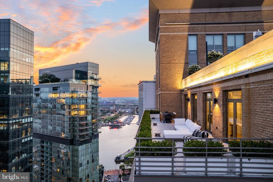 This exceptional corner Penthouse at The Vue boasts panoramic, unobstructed water and city views from every angle. Spanning nearly 3,900 square feet of interior and exterior living space, this impressive  three-bedroom, three-and-a-half-bath condo has been beautifully renovated to create a modern, move-in ready masterpiece. Featuring oversized glass French doors, high ceilings, two private terraces, and stunning vistas from every room, this residence is a true gem. Inside, you'll find lavish finishes including wide plank hardwood floors, designer lighting, custom tile, and a gas fireplace that sets an elegant tone for both daily living and entertaining. The living and dining areas flow seamlessly into the open Chef's kitchen with a spacious center waterfall quartz island, seamless quartz backsplash, custom cabinets, and top-of-the-line Viking and SubZero appliances. The primary suite is a haven of luxury with a walk-in closet and terrace access, while the primary bath features an oversized glass-enclosed shower with dual shower heads and a floating double vanity. Two additional bedrooms offer abundant natural light and skyline views, each with its own renovated en-suite bath. The professionally landscaped terraces flank the living space providing incredible outdoor living. This residence achieves the rare feat of being grandly scaled for entertaining while offering private and intimate spaces for day-to-day living, together with an indoor/outdoor lifestyle that exceeds all expectations. Two premier garage parking spaces convey. The Vue is ideally situated in Baltimore's most sought after neighborhood, steps from the city's finest restaurants, boutique shops, Whole Foods, Starbucks, the Inner Harbor, waterfront, and nightlife. The condo fee covers AC, heat, water, security, and concierge services. Take the elevator to the 2nd floor to access the MAC gym and Harbor East Cinemas adding to the convenience and luxury of this remarkable property.