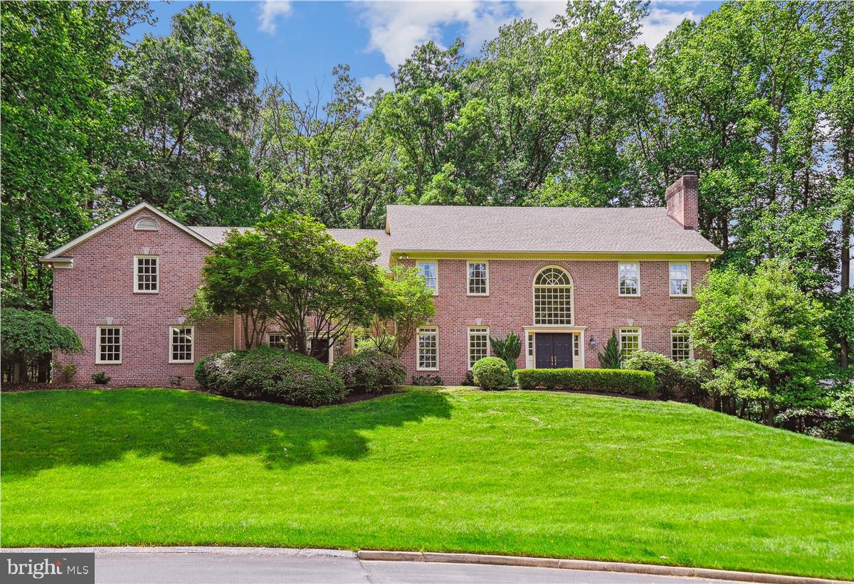Circular Drive leads to this impressive, over 7,000 sq. ft., all-brick Georgian-style home on 1.82 acres, situated in quiet Cul-de-Sac. Front double doors lead to a two-story foyer with an elegant curved staircase and Palladian window. This home features five bedrooms, five full and one-half baths, and 10’ ceilings on all three levels. Wide cherry hardwood flooring on the main level. Large Living Room with multiple windows with transoms and a fireplace. Pocket doors to Library/Office with Custom Built-ins and Window Seat. This room could be used as a bedroom if needed. It is right next to the full bath. The formal dining room has transom windows, intricate detail moldings, and a built-in cabinet. The kitchen features glass front cabinets,l plant shelf, a large Island seating five or more, a prep sink, a desk for recipe reading, or a bar. The kitchen table area is conveniently located next to the second staircase to the upper level. Hardwoods are under carpet on both staircases and in the upper hallway. The Family Room is off the Kitchen with Custom Built-ins, including a wet bar and Fireplace. Bright Light-filled sunroom with Palladian windows, Skylights, Ceramic Floor, Atrium Door to Trex Deck overlooking landscaped yard. The upper level features a large Primary Bedroom with a Fireplace, walk-in closets, a Luxurious Bath, expansive counter space, a makeup area, a Whirlpool Tub, and a separate shower. Three additional Bedrooms, One with a private Bath and the other two bedrooms with a Jack and Jill bath. The huge Bonus Room currently used as recreation/office has a private bath and balcony. This room could be used as an in-law suite. Outside this room is an Elevator Channel for possible future needs. This continues from the second floor to the first and also to the lower level. Expansive lower level with Walk Out to ground level has a raised hearth, brick fireplace and rough-in for bath. Four-car side entry Garage. The second Entrance Door from the front of the house leads into the Mud Room Area. Four Zone Heat. There is so much storage! Central Vac.