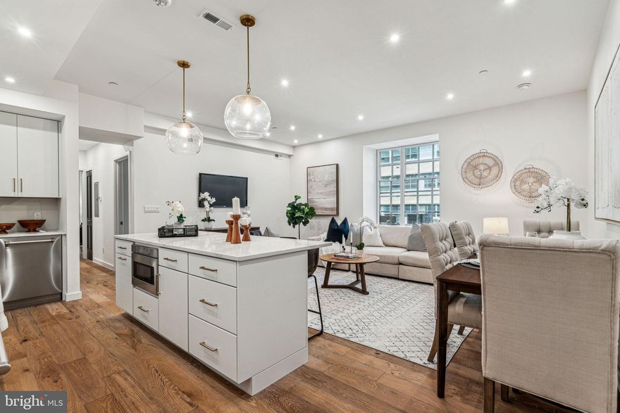 Turnkey, brand new construction at The Estate Homes at Parc Rittenhouse. Residence 206 is a 2 bedroom, 2 bathroom boasting an open floorplan with modern finishes and details. Enter the home into the great room featuring a chef's kitchen, ample space for living and dining, and a convenient coat closet. The eat-in kitchen has KraftMaid white cabinetry, Bertazzoni stainless steel appliances, Classic Calacatta quartz countertops and backsplash, and large center island with space for seating. Off the great room is a hallway leading to the bedrooms which includes the laundry closet with LG stacked washer and dryer. The primary suite is generously sized and features a large window and two oversized wall closets. The ensuite primary bathroom has a KraftMaid double vanity with quartz countertop and a large walk-in shower with designer quartz and marble tilework. The second bedroom also has a large window and nice closet space and enjoys use of a hall bathroom with a large KraftMaid vanity and walk-in shower. Additional highlights include hardwood floors and recessed lighting throughout. Residents of The Estate Homes at Parc Rittenhouse enjoy two secure elevators for only 20 homes which provides direct access to the garage, lobby and amenities floor, in addition to the same amenities as the other homes at Parc Rittenhouse, including a 24 hour doorman and concierge; landscaped 7th floor rooftop with outdoor pool, whirlpool spa, kiddy pool, and sundeck with lounge chairs; brand new state-of-the-art fitness center; conference room and media room. There is garage parking below the building for an additional fee and three amazing restaurants on the ground floor, Stephen Starr’s Parc, Devon Seafood and Via Locusta. Rittenhouse Square is ranked the 6th best neighborhood in North America by Places Rated Almanac. There are 175 restaurants and 199 retailers within a three block radius. Within close walking distance to the Market Street office corridor, The Avenue of the Arts and University City. 30th Street Station and Philadelphia International Airport are only minutes away.