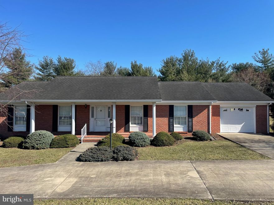 Town living with the feel of the country. Welcome home to this charming 3-bedroom, 2 bath, 1 1/2 lot property that offers the perfect blend of convenience and tranquility. With two spacious living rooms and a one-car garage, this home is ideal for entertaining and relaxation. Start your day on the covered porch, taking in the stunning sunrise and wildlife views on this oversize lot. The circular driveway adds a touch of elegance to your daily homecoming. Located close to shopping, dining, and entertainment, this property also offers easy access to George Washington National Forest for outdoor enthusiasts. Embrace the best of both worlds with this unique real estate opportunity that promises a peaceful retreat in a thriving community.