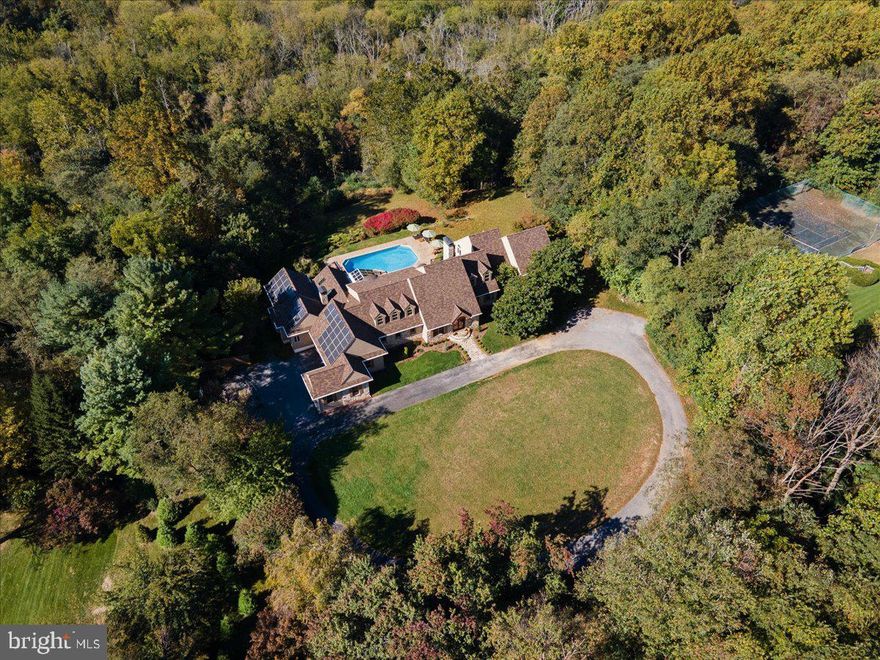 Wonderful new listing on 4.3 private acres on a high-rise overlooking the Brandywine River and 1200+ acre Cheslen Preserve. The Chestnut Hollow community contains just 12 homes, all on 4-5 acres, and all protected by wooded perimeters. This property is very spacious with over 11,000 sq ft of finished space including the lower level. There are 4 bedrooms and a 5th guest bedroom on the finished lower level. There are 4 full baths and 1 powder room. Beautiful glass double doors open to the foyer and a dramatic curved staircase. The step-down living room has beautiful hardwood pegged flooring (as is throughout most of the entire house, which was all recently refinished or added), a floor to ceiling fieldstone, wood burning fireplace and cathedral ceiling trimmed with reclaimed wood beams. The Dining Room is spacious and open and leads to an incredible kitchen area. This huge open area (formally 4 rooms) has all been remodeled (2022) by “Waterbury Kitchen” and hosts beautiful custom cabinetry, 2 Wolf ovens, a Wolf 6 burner with large grill cooktop, main sink and vegetable sink with reverse osmosis filtration, island with finished wood top and seating, large cooking area with counter seating for 8, beautiful stone counter tops throughout the kitchen, 2 Sub-Zero’s and 2 separate freezer drawers, prep areas, and brick surround gas fireplace. In the Sunroom Area is the breakfast area with fantastic rear scenic views. A brick floored area set up as a lounging area backed by a wall of windows. The kitchen opens at each end to a large and beautiful family room with high ceiling finished in shiplap boarding. A brick hallway leads to garage entrance, coat and hat cubby and pantry with reclaimed wood sliding barn door. Down the hall is a brick floored mudroom with lots of hooks and hanging areas for coats, knapsacks, shoes and a long bench. On the other side of the house is the 1st floor Main Bedroom remodeled with a fieldstone wall and a floor to ceiling double window overlooking rear views.  A doorway leads to 2 large walk-in-closets and makeup desk area.  There is a newly remodeled bath with soaking tub, large walk in shower finished in marble with glass surround, and a private water closet.  Windows abound and a glassed door leads to rear deck.  Past the bath is a large workout room with universal gym, high ceiling and numerous windows. Off the Main Bedroom is a new Laundry Room with washer/dryer hook-up, sink, and custom cabinetry.  A curved staircase leads to the 2nd floor open hallway overlooking living room and entrance foyer.  This level has 3 additional bedrooms, each spacious in size. There are 2 hall baths, one has recently been completely remodeled. On the main level, an open staircase leads to the finished lower level with new vinyl hardwood style flooring, an entry area, a game room and sitting room with sliders leading to rear patio and pool, a second game room is just off this area. To the back is the media room with ever changing color fiber optic ceiling lights. There is a full bath and changing room. This area is terrific for summer entertaining and pool parties. Through another doorway is a very large Hobby Room with shelving and storage and countertop with sink and storage cabinets. There are several unfinished areas offering lots of storage, and they also house the utilities and a second laundry area. Utility costs are well controlled and “Green” as there is a Geothermal HVAC system. The electrical system is supplemented by solar panels providing about 30% of electricity used. There is a Generac Generator with its own propane tank. The saltwater pool has an electric cover. All freshly painted interior, beautiful new landscaping, new high-end roof and sky lights, Trex deck, deer fencing, 2x6 construction, and many, many more improvements.  Award winning Unionville-Chads Ford schools.  This property represents one of the best values found in the ever popular Chester County. Don’t miss it!
