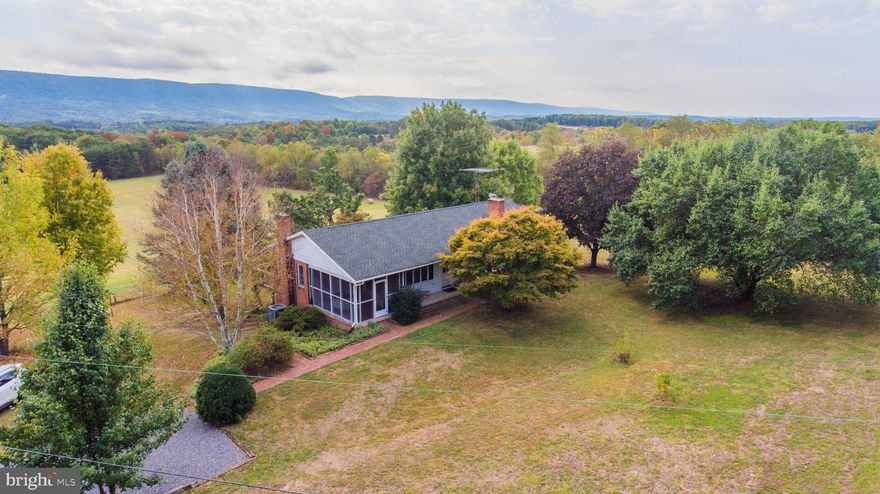 NOW IN MULTIPLE OFFERS.  PLEASE GIVE ME YOUR HIGHEST AND BEST OFFER BY 1:00 FRIDAY MAY 29, 2020. Multiple offer form in additional documents.  This house has been upgraded with new new laminate flooring in the basement and new drywall in the lower level bedroom due to mold mitigation.  Other improvement are a new UV light and Radon fan installed. THIS Beautiful Brick Rancher with an outstanding view across the valley of Sleepy Creek Mountain. Come into the house through the screened in porch and catch more views off the deck from the den with a propane heating stove.  Kitchen and dining room combo, living room with propane fireplace.  A master bedroom with full bathroom, 2 more bedrooms and a full bathroom upstairs.  Downstairs is a kitchenette, dining area and living room area, a 4th bedroom, a basement level garage, a laundry room, storage area, covered porch area to sit outside and see the view. About an acre is fenced in. A 50x50 Long Fence area for a garden. Country living at its best yet close to town.