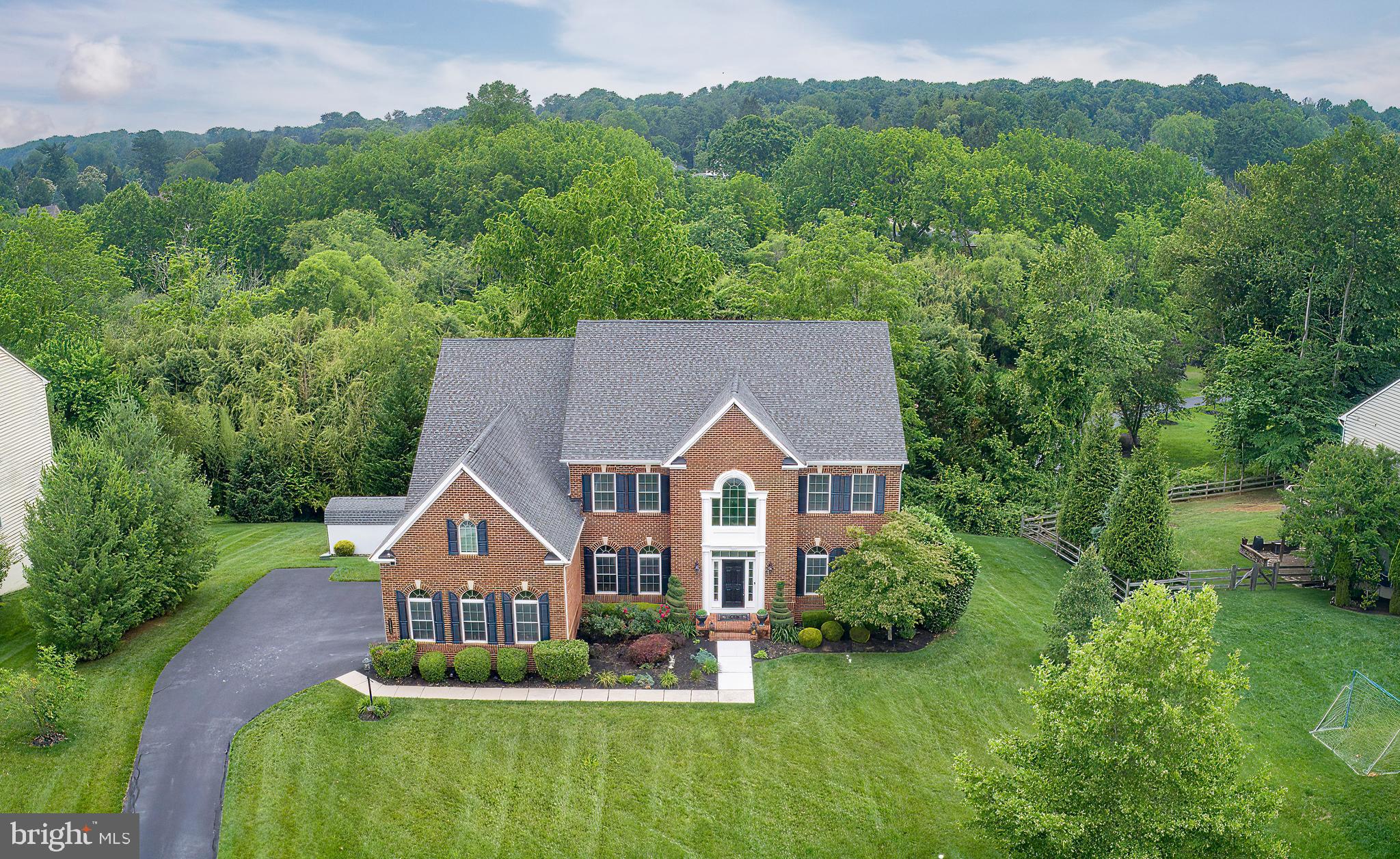 Step into nearly 5,000 square feet of refined living in this custom-built brick and beaded siding traditional home, where timeless elegance meets everyday comfort. A dramatic two-story foyer with dual staircases welcomes you into a sun-drenched interior designed for both grand entertaining and relaxed daily life.
The main level offers a seamless flow, featuring formal living and dining rooms with detailed crown molding, arched windows, and tray ceilings. The dining room is further enhanced with elegant chair rail molding. A butler’s pantry connects the dining room to the chef’s kitchen, offering added convenience and style for entertaining. The kitchen is outfitted with granite countertops, stainless steel appliances, double wall ovens, a stone tiled backsplash, and a bright morning room with access to the rear deck. A spacious family room with a custom built in , coffered ceiling and propane fireplace anchors the main living space. Gleaming hardwood floors extend throughout the first floor, with the exception of the study and living room. Additional highlights include a private home office, powder room, rear staircase, laundry room, abundant storage and a water softening system.
Upstairs, the luxurious primary suite is a true retreat, featuring a tray ceiling, dual vanities, an oversized glass shower with dual showerheads, soaking tub, private water closet, and two custom walk-in closets. Three additional bedrooms provide generous space, including a princess suite and a Jack-and-Jill bath—each with upscale finishes and thoughtful details.
The fully finished daylight walk-out lower level adds over 1,600 square feet of flexible living space, perfect for entertaining, guests, or multi-generational living. It features a stylish bar area with a stainless steel dishwasher, stainless beverage refrigerator, and glass display cabinets, along with open recreation areas and a powder room.
Built in 2012 and meticulously maintained, this home also includes a 3-car garage, recently replaced Trane HVAC systems with AprilAire, a 20 KW Generac generator, a custom Christmas light package, recessed lighting throughout, and ceiling fans with lights in every bedroom.
Located in the highly rated West Chester Area School District and just 1 mile from Chester County Hospital, 2 miles from the shops, dining, and nightlife of downtown West Chester, and with convenient access to Routes 322 and 202—this is luxury living in a location that truly delivers.
***Don't miss our exclusive website for this home, featuring a 3D Matterport tour, Virtual Reality Walkthrough, detailed floor plan, professional photography, aerial drone neighborhood footage. Note: Some photos have been digitally enhanced.***