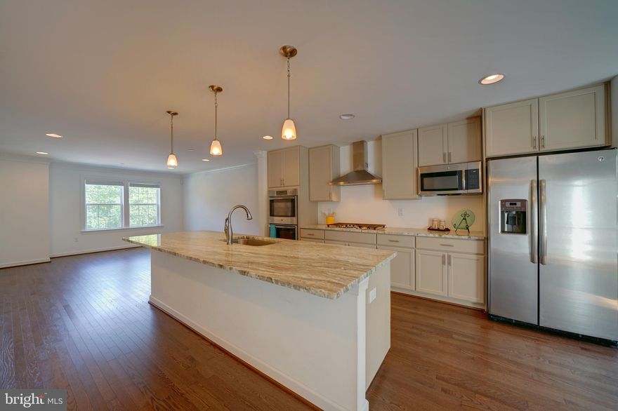 Simply perfect! This garage townhome has been so well maintained. Clean. Looks like it was hardly lived in for the past 2 years. 3 levels of upgrades are evident. Main level entry in foyer. Wood stairs with wrought iron railings. Garage with opener. Family room w gas fireplace. Slider to rear yard. Gas heat. Powder room on entry and main levels. Recessed lights on every floor in addition to the abundance of windows with views and great positions for natural light. The main level is open from front to back. Center kitchen with big island. Quartz countertops, SS apps, beautiful cabinetry. Gas cooking with exhaust. Double ovens. Microwave. Wood flooring. Slider to composite deck overlooking the treed backdrop. Upper level bedrooms w/2 full baths. Laundry room conveniently located outside in the hallway. Vaulted ceilings. Located in Columbia just minutes to downtown. Convenient to major routes and commuter bus lines. Enjoy the Columbia amenities including lakes, trails, events including concerts and arts. Small town with big city events! Enjoy the best that Howard County can offer within minutes from your own front door. This townhome has all that and more!