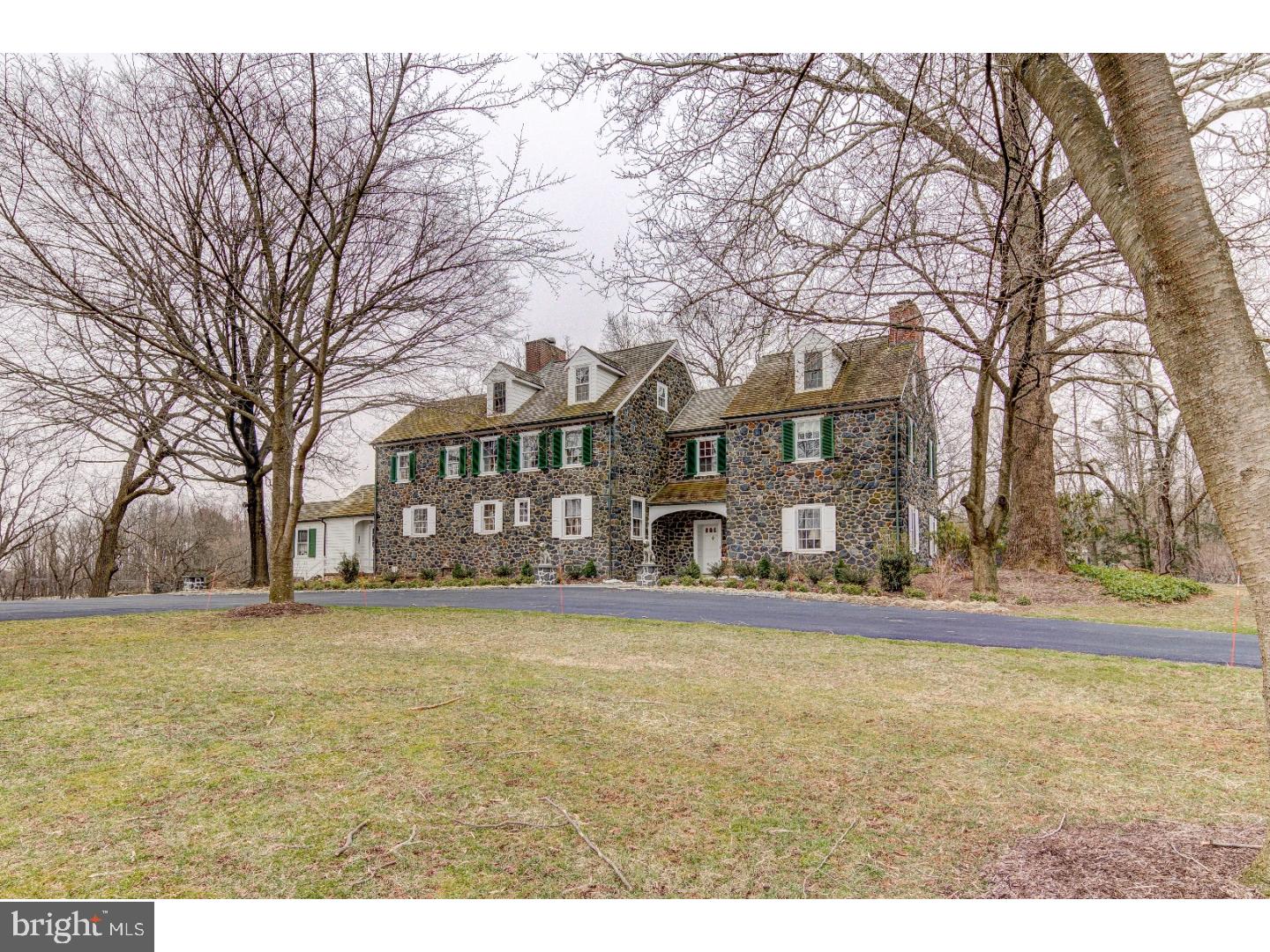 Welcome to Spring Stone Farm. This historic stone farmhouse combines old world charm with modern conveniences. The previous owner updated all systems in 2011, and the current owner made the cosmetic renovations and repaved the driveway, adding the circle in front of the house. Enter the gated driveway to the house at the top of the hill. As you pass through the front door into the front hall you will see the formal living room to your right with a fireplace and windows on three sides. To your left you will see the library with three walls of built-in bookshelves and its own private half bath. Next to the library is the dining room large enough for a big table to entertain all your guests. Beyond the dining room is the kitchen with attached sun room. The kitchen was recently updated with white cabinets, chrome hardware, soapstone counter tops, Sub Zero refrigerator and freezer, and fireplace. Attached to the kitchen is the sun room with floor to ceiling windows overlooking the slate patio and gardens. Make your way up the curved staircase to the second floor where you will find the guest bedroom with its own bathroom, the old master bedroom with newly renovated marble en-suite and the new master bedroom with newly renovated marble bathroom complete with a glass and marble steam shower. After checking out these two spa-like master suites, head up to the third floor. Previous owners listed the third floor as containing 2-bedrooms. The current owner's teenage son uses this area as a one-bedroom suite with a lounge and full bath at one end and a bedroom at the other end. On the third floor you will also find the massive cedar closet with plenty of storage for fine clothing, luggage, and everything else. Once you finish roaming this magnificent house, make your way outside and walk the nearly 7 acre grounds. This estate comes complete with flower gardens, a 4 car garage, raised bed vegetable garden, and 5 acres of fenced land for pets to run. Seller's agent is related to seller.