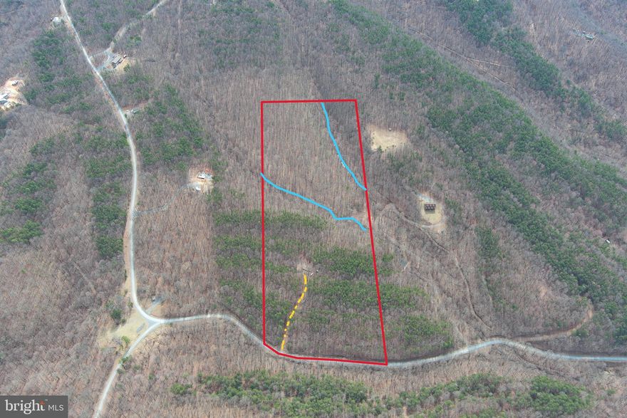 RUNOFF...... IT'S TIME TO RUN OFF TO THE MOUNTAINS! 20 WOODED ACRES OF GENTLE 100% USABLE LAND WITH 500 FT GRAVEL DRIVEWAY INSTALLED TO SPACIOUS CAMP SITE AND 2 SEASONAL MOUNTAIN RUNOFF STREAMS FLOWING THROUGH THE PROPERTY. PINES IN THE FRONT AND MOSSY FLOORED HARDWOOD FOREST IN THE BACK....EASY TO HIKE, BIKE, ATV & HUNT.  BEST BUILD SITE IS ABOUT 60 YARDS BEYOND THE EXISTING PAD AND OFFERS NICE VIEWS OF SOUTH BRANCH MOUNTAIN AND THE OAK HOLLOW & STREAM BELOW. POWER, PERKED & FIBER AVAILABLE......EASY IN, EASY OUT.....ONLY 3 MILES OFF THE PAVED ROAD, NO TREACHEROUS OR TWISTY ROADS TO DEAL WITH. LOCATED IN THE PRESTIGIOUS 10,000 ACRE GATED COMMUNITY ASHTON WOODS, A ONE OF A KIND PLACE, WHERE YOU CAN ESCAPE THE WORK & WORRY OF THE BIG CITY AND TICKLE ALL YOUR OUTDOOR FANCIES....15 MINUTES OFF 4 LANE SUPER HIGHWAY, 10 MINUTES FROM MULTIPLE PUBLIC ACCESS POINTS ON THE SOUTH BRANCH OF THE POTOMAC RIVER, 15 MINUTES FROM MOOREFIELD, 45 MINUTES FROM SKI RESORTS, 5 MINUTES FROM PRIVATE COMMUNITY ACCESS TO NATHANIEL MOUNTAIN WILDLIFE MANAGEMENT AREA 10,000 ACRES OF PUBLIC HUNTING & HIKING.....IF YOU LIKE THE OUTDOORS, YOU'LL NEVER RUN OUT OF THINGS TO DO.....WHO KNEW? ALL OF THIS WITHIN 2 HOURS OF DC.....BELIEVE IT! FINDING A NICE LOT IN ASHTON WOODS IS PRETTY HARD THESE DAYS DUE TO THE HIGH DEMAND AND LOW SUPPLY, THIS OF ONE OF THE BEST LOTS OFFERED IN THE LAST 2 YEARS! BETTER GET ONE WHILE YOU CAN.....MAKE THE CALL, MAKE THE DRIVE AND MAKE THE DEAL! THIS LOT IS OF THE HIGHEST QUALITY AND WILL NOT DISAPPOINT!