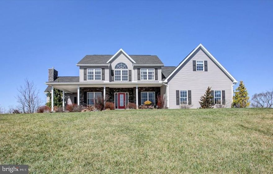 HILLTOP VIEWS! Sitting high on 2 acres with gently sloping private fenced backyard, this custom built 2 story home won't disappoint.  CAR ENTHUSIASTS take note as this home offers 4 car attached garage w/2 bays having 10'x12' O.H. doors & a car lift.  Garage area is fitted with mini-split and 1/2  bath w/large paved parking area outside.  The 3,400+ sq. ft. home features upgrades throughout: hardwood floors, 18' ceiling family room w/stone (gas) FP, custom cherry kitchen w/granite and large center island w/vegetable sink, primary main level bdrm., w/(2) walk-in closets & bath w/(2) separate vanities, jetted tub, separate tile shower & access to covered rear porch, open foyer w/2  stairways to 2nd floor (one from foyer & one from kit), central vac, upgraded trim package, (3) HVAC units & sitting room on 2nd floor overlooking family room.  Bonus room on 2nd floor is listed as 4th bdrm., but currently used as den w/access to 12'x26' unfinished storage area that could be finished for additional 300 sq. ft. of living space.  Basement has walk-out to grade steps, 9' ceilings, freestanding gas stove w/stone hearth & wall, rough-in plumbing for full bath making the basement area ideal to finish for more living space.  Interior of home is in excellent condition while exterior provides ample amenities, privacy and views: large wrap around front porch & covered rear porch overlooks large backyard to wooded backdrop.  On the edge of town, the location is convenient yet private w/country views.  This is a must see for someone looking for a quality, upgraded tastefully built home w/country size lot and a 4 car attached garage as a bonus!