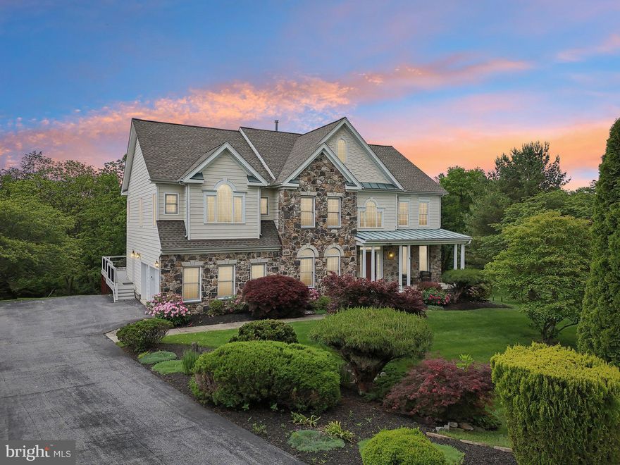 Step into elegance with this breathtaking 5-bedroom, 4.5-bath home, perfectly nestled among tranquil, scenic views. From the moment you arrive, this home makes a statement – impeccable curb appeal, a spacious driveway, and an attached garage offering abundant parking welcome you home.

Start your mornings with coffee on the rear deck, overlooking a serene, wooded landscape as the sun rises — the perfect blend of peace and privacy.

Inside, you'll be wowed by the bright, airy interior featuring hardwood floors throughout all three levels. Soaring high ceilings, an open-concept layout, and walls of windows flood the living spaces with natural light. Cozy up by the fireplace in the inviting living room, seamlessly connected to a sophisticated dining area and a chef’s delight kitchen – complete with a large island, stainless steel appliances, under-cabinet lighting, sleek finishes, a Jenn-Air cooktop (2022), and a new LG refrigerator (2024).

Just off the kitchen, the sunroom retreat offers year-round enjoyment and direct access to the newly built deck (2022) — an ideal place to relax or entertain while soaking in views of your lush backyard oasis.

Upstairs, discover a luxurious primary suite with a spa-inspired ensuite: jetted soaking tub, glass-enclosed shower, double vanities, and a private water closet. Three additional spacious bedrooms include a junior suite with its own full bath, plus an additional hallway guest bath.

The partially finished walk-out basement is an entertainer's dream – warm up by the second fireplace, host guests in style, and take advantage of the bonus bedroom and full bath, perfect for visitors or extended stays.

This home has been well maintained and thoughtfully updated, including a new roof and well pump (2020), reverse osmosis water system, whole-house water softener and a 2025 septic inspection already complete for your peace of mind.

This beautiful gem blends timeless charm, modern convenience, and ultimate comfort — don't miss your chance to own this slice of paradise. Private tours available soon — schedule yours before it's gone!