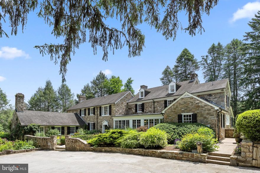 NEW PRICE!!  Magnificent Estate situated on a bucolic 26+ acre hillside just outside of West Chester in the nationally ranked Unionville-Chadds Ford School District, that has not been on the market for 24 years. This unique Chester County compound has incredible stonework throughout the property, including the Majestic Stone Farmhouse, Pool House, Guest House, Art Studio and stone walls throughout! Breathtaking entrance with a long drive leading by a stream and pool house to the Main House. There is an approximately 8-acre vineyard on two of the separate lots featuring award winning Cabernet Franc, Gruner Veltliner and Albarino grapes. The original farmstead was built in the 1800’s with additions in the 1920’s and 1970’s. Extensive renovations were done by the current owners over the years, including new Main House kitchen and bathrooms, as well as converting the stables into an Art Studio and the Pool House with a beautiful guest suite. The stunning Stone Farmhouse entrance walks you through stone walls and beautiful gardens with a Koi Pond into a front to back entrance hall and out to a terrace with views of the stream, open space and woodlands, planted by the current owners. This 5 bedroom, 4 full and 1 half bath is a private retreat with stunning areas throughout for outside entertainment and enjoyment. Stonework through the interior of the house highlights walls and fireplaces with exquisite woodwork and moldings throughout. A large gourmet kitchen with breakfast nook is surrounded by exposed stone walls with a butler pantry leading to a bright dining room with access to a lovely terrace. The second floor has a primary suite with sitting area and ensuite bath all with great light. There are 3 additional bedrooms and a full bath. Beautifully proportioned and elegant living room with a marble surround fireplace and built-in bookcases. Completing the first floor is a large stone walled office, den and mudroom with a separate kitchen entrance. There are 3 additional bedrooms and a full bath. The property includes a 4,000 sq.ft. Guest House, currently being used as a combination of offices and living space perfect for family or weekend guests. The 2 story Pool House was completely rebuilt to include another weekend getaway for guests, featuring a loft bedroom, full kitchen and stunning bath and stone fireplace. A perfect setting for the pool surrounded by stone walls and hydrangea trees. The original stable was converted into a large, magnificent art studio with separate areas for a wood shop, library/photo darkroom, painting, mosaics, ceramic kiln and welding shop with barn doors. The Art Studio has windows throughout facing the vineyard and French doors that open to a terrace with stone surround and views of this exquisite property. A newly built 4 car detached garage is also on the property. This property is comprised of 3 tax parcels. The main parcel is 12 acres with 2 additional lots. Lot 1 is 8.2 acres and includes the home vineyard and Lot 2 is 6.2 acres. In a prime location close to Longwood Gardens with easy access to Philadelphia, Wilmington, West Chester, shopping, restaurants and much more!