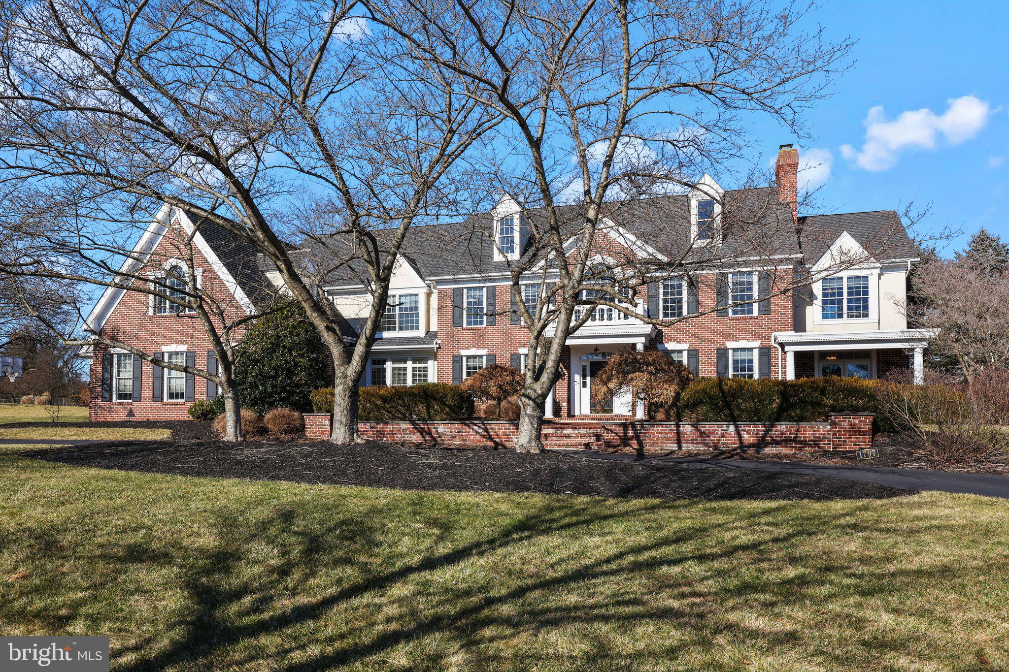 Discover the epitome of luxury living in Worcester, Pennsylvania, at 1797 Hawks Nest Lane in the prestigious Fawn Creek neighborhood. This Georgian Brick Colonial masterpiece stands as a testament to grandeur and elegance, nestled on 1.5 lush acres. Offering nearly 6,000 Sq/Ft of exquisite living space, this residence features four bedrooms, five baths, a three-car attached garage, a game room on the 2nd floor, an expansive full unfinished basement, and a breathtaking custom Anthony & Sylvan pool, complete with a cascading waterfall.
Upon entering the grand foyer, the allure of classic hardwood floors, arched ceilings adorned with dentil crown molding, wainscoting, and a majestic solid oak staircase greet you. The home’s sophisticated design is further accentuated by enlarged windows, custom crown woodwork, and a striking chandelier. The inviting layout includes a home office space with elegant French doors in a sun filled room, leading to an intimate Pennsylvania Blue Stone patio with a firepit. A sun-drenched, tile-floored sunroom and a convenient half bath near the office entrance provide serene retreats.
The formal living room welcomes you with a gas fireplace, adorned with a gorgeous marble-surround, intricate mantle, and high ceilings. The large dining room has enough room to fit 12+ people.
The brand new chef’s kitchen boasts a sprawling center island, top-tier Thermador and Bosch appliances, a walk-in pantry, brand new Raised Panel cabinets, and gleaming quartz countertops. This culinary haven opens to a cozy breakfast area and a great room anchored by a brick front gas fireplace for ease of entertaining.
The luxurious main bedroom on the second floor features a private sitting area, dual walk-in closets, and a spa-like bath with a jetted tub and dual vanities. The three large additional bedrooms offer ample storage and walk-in closets, alongside a charming library/den with panoramic views. An expansive bonus room above the garage offers versatile space, possible two additional bedrooms.
The elegant patio, leading to the 30,500-gallon gated Anthony & Sylvan pool, serves as a private oasis for relaxation or entertaining. This property also comes equipped with a robust 27 kW Generac generator that turns on automatically if the power goes out. It is strong enough to power the whole house.
Recent updates include new bedroom carpeting, a new kitchen and updated breakfast area flooring, and a freshly replastered pool. Don’t miss the opportunity to own this unparalleled property, where luxury meets comfort. Schedule your visit to 1797 Hawks Nest Lane and embrace the lifestyle you deserve.
