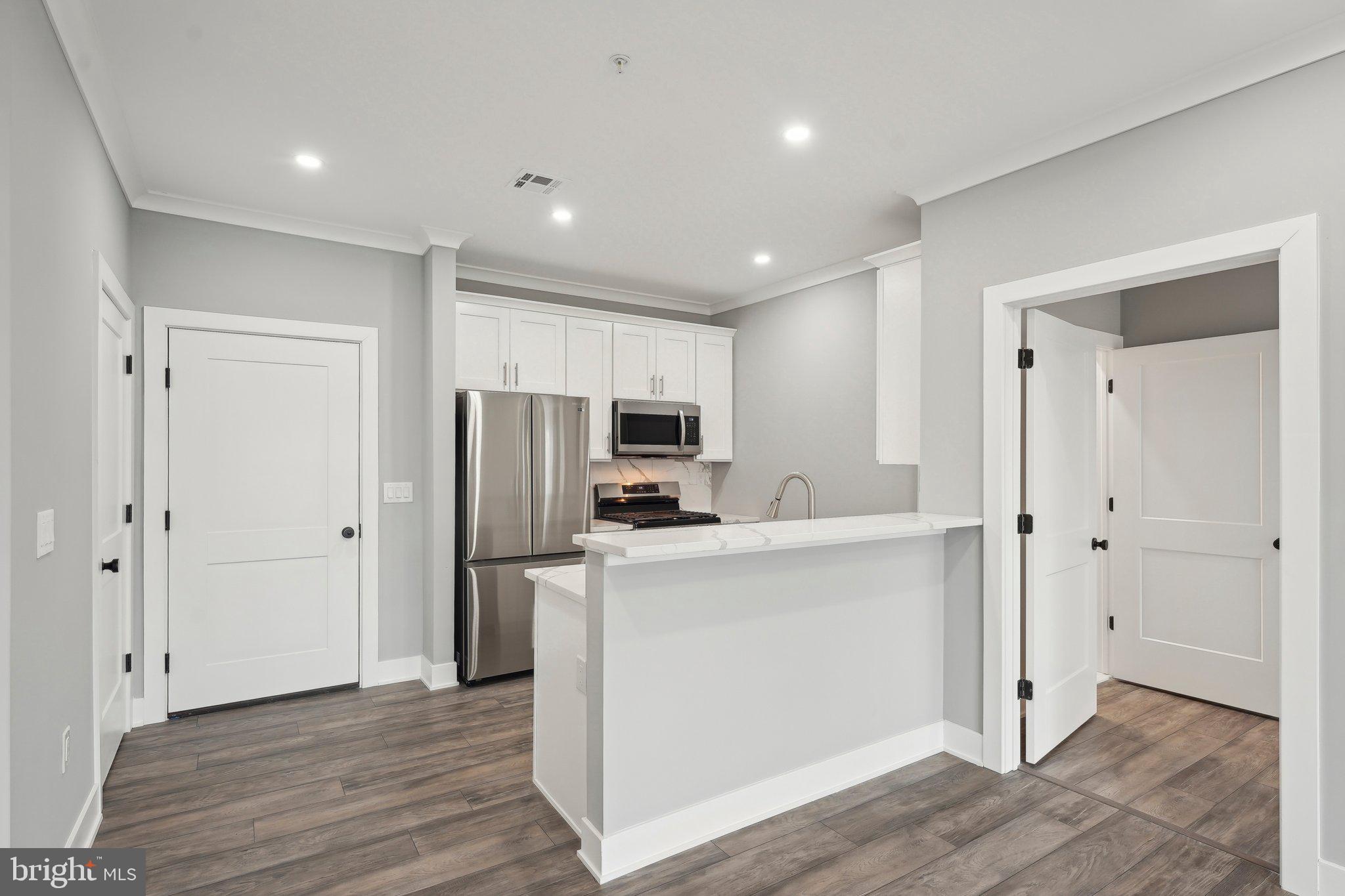 Nestled at 2421 Bristol Road in the heart of Warrington, Pennsylvania, The Warrington Place is a thoughtfully crafted residential community that blends upscale finishes, modern conveniences, and timeless style. Offering one-, two-, and three-bedroom apartment homes, the property is designed to meet the needs of today’s renters who value both form and function in a refined, suburban setting.
Inside each residence, you’ll find open-concept floorplans that maximize natural light and flow, creating a welcoming atmosphere ideal for relaxing or entertaining. The apartments feature soaring nine-foot ceilings and oversized windows, enhancing the sense of space. Gourmet kitchens are outfitted with sleek stainless steel appliances, white shaker-style all-wood cabinetry, quartz countertops, subway tile backsplashes, and oversized islands or breakfast bars in select layouts—perfect for morning coffee or evening meals. Luxury vinyl plank flooring throughout the main living areas adds a stylish, durable touch, while plush carpeting in the bedrooms provides cozy comfort.
Each apartment also includes smart Samsung appliances such as in-unit washers and dryers, allowing residents to handle laundry at their convenience. Spacious bathrooms feature modern vanities, chrome fixtures, and tiled showers or deep soaking tubs. Large walk-in closets provide generous storage, and private balconies or patios in most units offer a quiet space to enjoy the outdoors. Select homes offer premium views or corner locations for even more natural light and privacy.
Beyond the units themselves, The Warrington Place provides a well-maintained environment with controlled access entry, ample private parking, and professional on-site management. The community is located at the intersection of Bristol Road and Route 611, giving residents unbeatable access to major retail destinations and everyday essentials. Whole Foods, Wegmans, Giant, Target, Walmart, Costco, Amazon Fresh, and ShopRite are all within a short drive, making errands quick and easy. Public transportation is also convenient, with a nearby SEPTA bus stop offering a simple commute for those who prefer not to drive.
Warrington itself offers a charming, residential atmosphere with the conveniences of modern suburbia. Residents will enjoy close proximity to a variety of restaurants, local parks, fitness centers, and entertainment venues such as the Regal Cinema. The area is known for its peaceful streets, well-maintained green spaces, and an easy-going pace that makes coming home feel like a true retreat.
The Warrington Place is more than just a place to live—it’s where style meets substance, and convenience meets comfort. Whether you're a busy professional, a downsizer, or someone seeking elevated suburban living, this community delivers a lifestyle that feels both luxurious and effortless.
** Photos are of model units ** Pricing and availability subject to change on a daily basis **