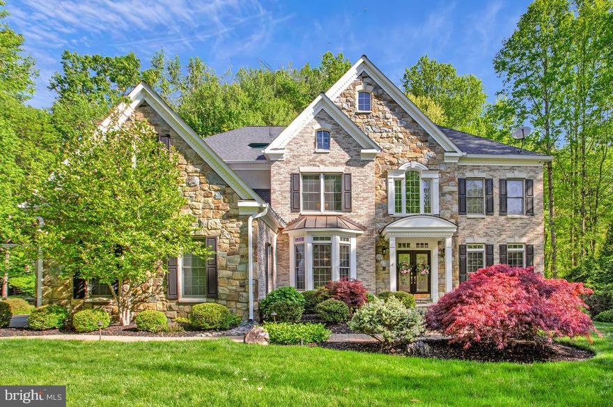 Fully renovated luxury estate on nearly one acre in the sought-after Ashley community of Davidsonville, offering over 7,300 sq ft of finished living space, including 5,572 sq ft above grade. This move-in-ready home blends scale, privacy, and high-end upgrades rarely found in a single offering.

A dramatic two-story foyer and family room with soaring ceilings and gas fireplace anchor the main level. The fully renovated gourmet kitchen features custom cabinetry, oversized quartz island, Bertazzoni gas cooktop, Bosch double wall ovens, and a brand new Sub-Zero 36” built-in refrigerator. Butler’s pantry includes wine storage, wine refrigerator, ice machine, and additional beverage storage. Sunroom/observatory with double-sided fireplace provides abundant natural light and year-round enjoyment.

Hardwood flooring extends throughout the main and upper levels, creating a seamless, elevated look, and has been professionally refinished to enhance both beauty and durability.

Main level includes a dedicated executive office with wall-to-wall custom built-ins, along with formal and open living spaces ideal for entertaining.

The upper level features a spacious primary suite with tray ceiling, sitting area, and fully renovated spa-style bath with heated floors, oversized multi-head shower, and dual vanities. All bathrooms throughout the home have been fully renovated with modern finishes.

The finished lower level offers exceptional flexibility with a private guest bedroom hidden behind a custom feature wall with concealed double-door entry, full bath, dedicated fitness area, and expansive entertainment lounge with custom cherrywood wall unit, integrated television, Bose surround sound, and theater-style reclining seating. Bar area includes built-in cabinetry, full-size refrigerator, and additional cold storage, along with a separate office workspace with dual built-in desks.

Outdoor living is designed for both relaxation and entertaining with a multi-level deck, gazebo, outdoor kitchen, professional landscaping, irrigation system, landscape lighting, and fenced backyard backing to wooded privacy.

Additional features include natural gas heating and cooking, Generac home backup generator, new water heater (2024), roof replaced (2021), dual-zone HVAC, ADT security system with CCTV, and a three-car side-entry garage with epoxy-coated flooring, equipped with an EV charging port and pre-wired for a second charging station.

Select premium features convey, including Samsung Frame TVs, custom media console, theater seating, built-in office workstations, dining table with bench and chairs, outdoor furniture, mini freezer for additional storage, and fitness equipment including Tonal system, Smith machine, and dumbbell tower set.

Conveniently located with access to major commuter routes and zoned for top-rated Davidsonville schools.