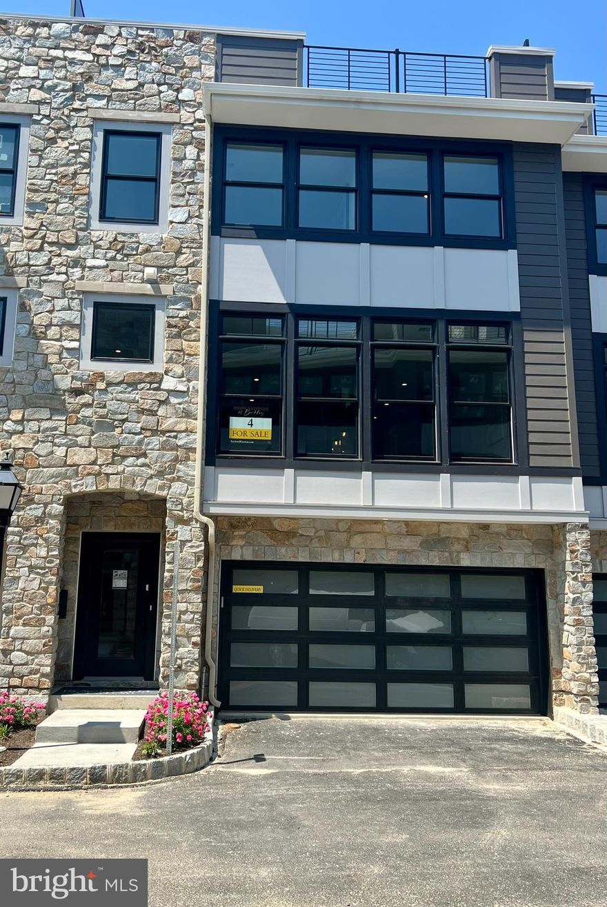 Discover one of the last two homes in the heart of Devon, where 7 luxury townhomes are being built. This exquisitely appointed home offers convenience and style, just minutes away from shopping, dining, and train stations. Step inside to find a main floor with a foyer, garage access, mudroom, and a versatile flex space complete with a full bathroom. The main level showcases 10' soaring ceilings and an open floor plan, highlighted by a spacious great room with oversized windows and a gas linear fireplace. The kitchen is a chef's dream, featuring custom cabinetry, a 12-foot island, quartz countertops, stainless steel appliances, and custom lighting. Additional amenities include a pantry, wet bar, and dining area. Upstairs, the owners' retreat awaits with a spacious custom closet and a private en-suite bathroom. Two more generously sized bedrooms, a hall bathroom, and a laundry room complete the second floor. An elevator takes you to the 4th-floor loft, offering additional living space, a wet bar, and a half bathroom. The crown jewel of this home is the 400 sq ft rooftop terrace, complete with an outdoor kitchen for ultimate relaxation and entertainment. This move-in ready home is available for immediate occupancy. Don't miss out on this extraordinary opportunity to experience a luxurious lifestyle.