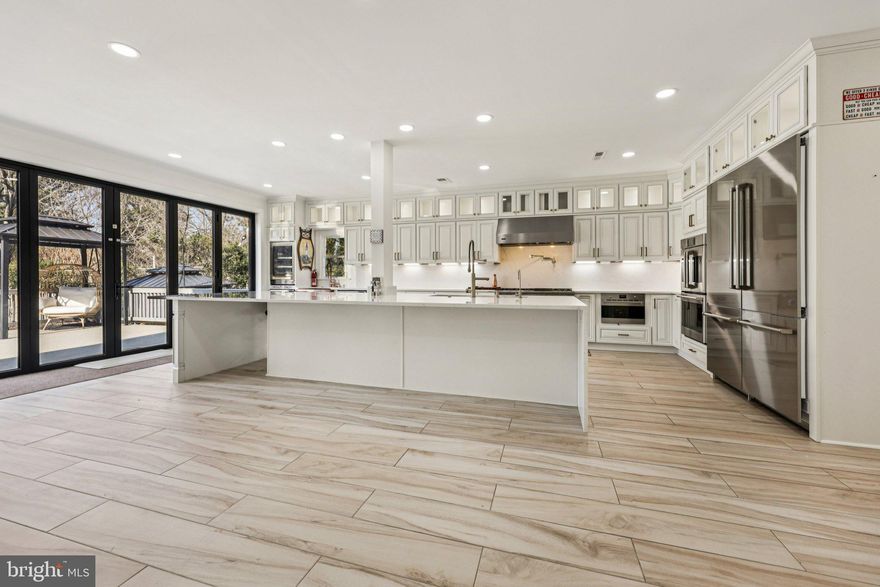 Stunning Fully Upgraded Smart Home with Premium Modern Finishes

$600K+ Upgrades in 2025| 5,500+ Sq Ft | Turnkey Luxury

Welcome to this exceptional East‑Facing Cambridge model in Chantilly, offering 5,500+ sq. ft. of sun‑drenched, thoughtfully designed living space. Fully renovated inside out in 2025, this residence showcases premium finishes, energy‑efficient systems, and an impressive suite of WiFi‑enabled smart‑home Appliances and features, Brand New Windows and Doors, New Composite Deck, advanced safety locking systems, smart thermostats, perimeter cameras and adjustable LED ambiance lighting throughout. With its expansive front yard, refined upgrades, and uniquely crafted floor plan, this home delivers a seamless blend of modern luxury, comfort, and everyday functionality.

First Level : Step into an inviting foyer that sets a refined and memorable first impression, unfolding into a stately, sun‑drenched formal living room anchored by an elegant gas fireplace. A beautifully appointed main‑level bedroom with a full standing shower adds exceptional versatility—perfect for guests, extended family, or a private work‑from‑home retreat. A dramatic 16‑foot, six‑panel glass bifold door opens completely to reveal an expansive 30‑foot deck, creating a seamless indoor‑outdoor flow into the serene, thoughtfully landscaped backyard oasis—an idyllic setting for gatherings, relaxation, and elevated everyday living.

At the heart of the residence lies a sophisticated chef’s gourmet kitchen, meticulously crafted with premium finishes, high‑performance appliances, and an intuitive layout designed for both culinary mastery and effortless entertaining. A commanding 15‑foot waterfall quartzite island offers seating for ten and serves as a stunning centerpiece for celebrations and everyday enjoyment. Matching quartz countertops and full‑height backsplashes wrap the space in refined elegance. A curated suite of professional grade appliances elevates every culinary experience with a Kitchen triangle Design template: a Viking 48” six‑burner gas range with commercial hood, a ZLINE 60 inch double‑door refrigerator, multiple BOSCH and Fisher & Paykel dishwashers, ZLINE stacked double ovens, a beverage cooler, and a 60‑bottle wine cooler—all Professional appliances selectively picked for exceptional performance, Speed and effortless hosting. Luxury continues with a designer pot filler, an integrated microwave/oven combo, a 44” stainless‑steel prep‑station sink, a hammered copper secondary sink, and a Brizo tankless 6‑stage reverse osmosis system for pristine drinking water setup. Custom flush‑mounted cabinetry, under‑cabinet LED lighting, and illuminated display cabinets add architectural sophistication, while sleek porcelain flooring completes the modern, gallery‑like aesthetic.

Upper Level: showcases four spacious bedrooms, three fully remodeled en‑suite bathrooms, and a thoughtfully designed private office. Each bathroom has been elevated with ceiling height luxury porcelain tile, custom solid‑wood cabinetry, and recessed lighting across all rooms, creating a bright atmosphere. The primary suite impresses with high ceilings, generous proportions, and a serene spa‑like en‑suite bath featuring seamlessly integrated second‑level laundry access—a rare and refined convenience. A creative redesign also introduces a private office, ideal for work, study, or a quiet personal retreat.
Lower Level: The lower level offers a spacious, relaxing retreat complete with a fifth full bathroom, a second laundry room, and abundant storage. This versatile area provides the perfect setting for recreation, extended‑stay guests, or a private getaway within the home.
Backyard & Exterior:  Set on a generous 0.49‑acre lot, the property offers an exceptional outdoor living experience. A 30‑foot, long‑lasting composite deck (built 2025) extends the entertainment space.