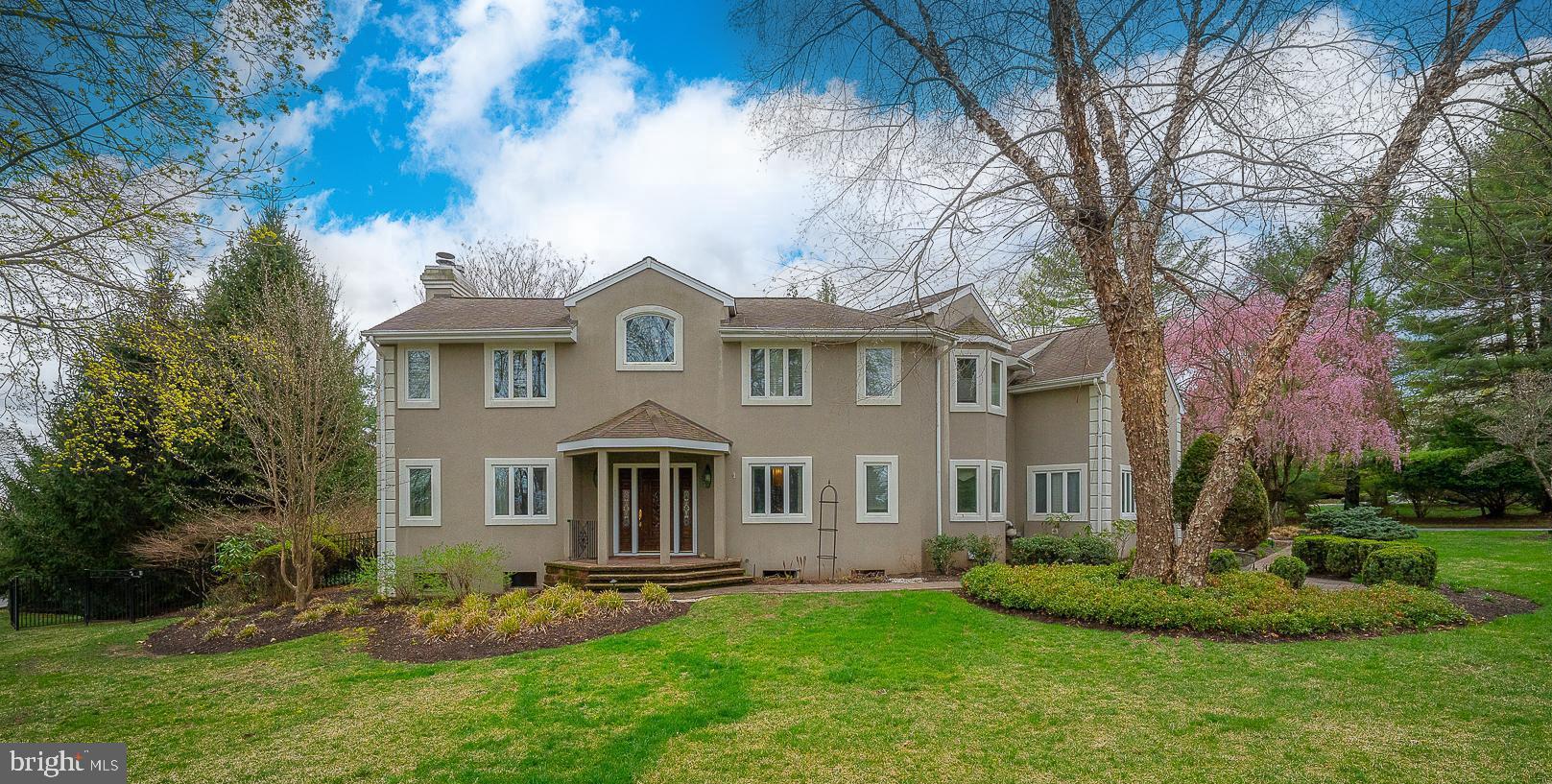 Nestled on a picturesque 0.61-acre lot, this expansive 4,100+ sq. ft. contemporary home blends elegant design with everyday comfort. The entrance hall welcomes you with marble flooring and stately pillars. Soaring ceilings, thoughtfully curated selection of flooring material, define the main living spaces, with French doors offering seamless indoor-outdoor flow. The formal living room with a soaring two-story ceiling features a beautiful fireplace with marble surround and wood mantel. Step outside to the partially covered back patio, overlooking the fenced backyard and inviting in-ground pool—a private oasis for entertaining or relaxation. From the formal Dining Room, enter into the chef’s Kitchen which was designed for both function and style. It boasts high-end stainless steel appliances, a center island, breakfast bar, peninsula with seating for 3, granite countertops, and extensive cabinetry including 2 pantries. Adjacent, the breakfast room with views of the private backyard overlooks the Family Room with built-ins and stone fireplace. The second-floor loft overlooking the living room is equipped with built-in desks and custom shelving, perfect for a home office or study space. The primary suite is a sanctuary, offering three walk-in closets and a spa-like bath with an oversized frosted frameless glass shower, double shower heads, glass mosaic backsplash, and custom finishes. There are 3 fantastic additional bedrooms (one with an en-suite bathroom) that provide generous storage, ceiling fans, and natural light. A hall bathroom completes this floor. The finished basement expands the living space with multiple versatile rooms, ideal for a home gym, hobby area, or media room, along with ample storage and an exterior entry. The three-car garage with epoxy flooring and driveway complete this exceptional property. This Must See home is conveniently located, just minutes to shops, restaurants, and expressway to Center City. Lower Merion School District!