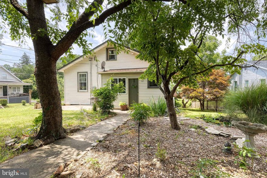 Charming and full of character, this 1921 single family home blends original details with thoughtful updates. Enjoy summer evenings on the inviting front porch before stepping into a sun-filled interior featuring hardwood floors and a cozy wood-burning fireplace. The updated kitchen has been opened up to create a bright, functional space with stainless steel appliances and generous pantry storage. All three bedrooms are conveniently located on the main level. The full bathroom has been beautifully renovated with a modern wet-room layout, showcasing a freestanding tub and dual shower heads. Upstairs, the newly finished attic (2023) with insulation and lighting provides flexible bonus space, perfect for a library, home office, or playroom. Additional highlights include a convenient mud/laundry room off the rear entrance, a large backyard, and a paved parking pad. Ideally located near major highways for easy commuting. A truly special home with warmth, space, and versatility!