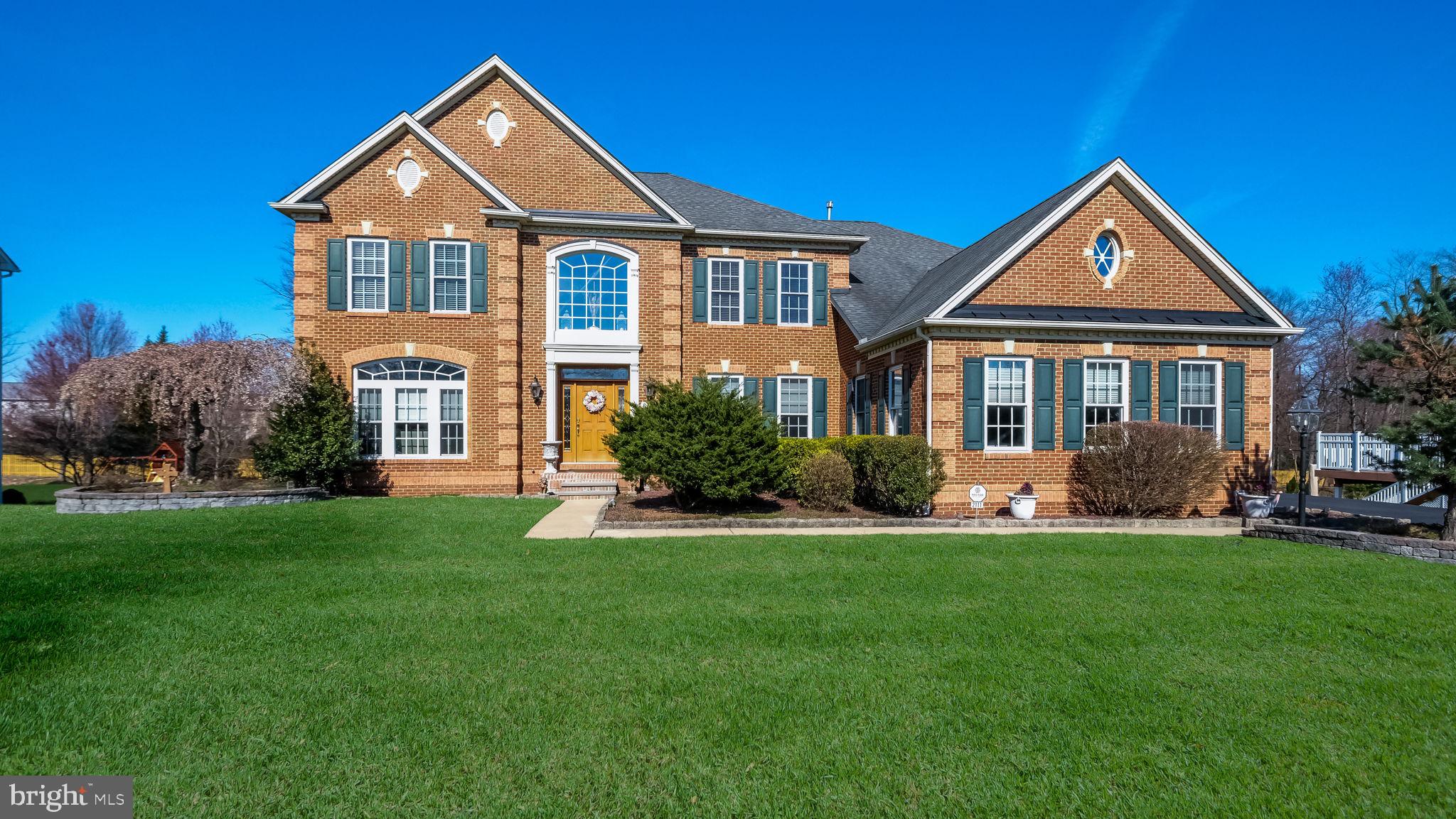 Welcome to this gorgeous 4-5 BR, 5 full Bath Brick front Colonial in Ashton Reserve! Custom front door with leaded glass transom windows open into the 2-story Foyer with hardwood floors, custom molding & turned waterfall oak staircase with oak railing & painted balusters. Custom Columns into the Formal Living room off the Foyer with double crown molding, chair rail, hardwood floors & gorgeous triple-arched window plus a floor-to-ceiling bump-out with triple window. Formal Dining Room with tray ceiling, custom crown molding & custom wainscoting with chair rail. Large Kitchen with center island, 42" solid Hickory cabinetry, granite countertops, stainless steel appliances including a gas cooktop with built-in microwave above, double wall oven & built-in dishwasher; double Stainless steel sink, custom ceramic tile backsplash, under cabinet lighting, Breakfast bar with seating for 3 & ceramic tile floor that continues through the Breakfast room & Morning/Sunroom. The kitchen opens to a Breakfast room with floor-to-ceiling windows & back staircase overlooks the Morning room/Sunroom with a cathedral vaulted ceiling with ceiling fan, floor-to-ceiling windows & French doors leading to the beautiful 28 x 20 Composite deck. The hallway leads from the Foyer to the Family room with a columned entry, floor-to-ceiling stone fireplace & wall-to-wall carpet. The first floor also offers a Study, full bath with a walk-in shower & Laundry room with built-in cabinetry & shelving. The second floor offers a Primary Bedroom Suite with a wall-to-wall-carpet, tray ceiling with crown molding & ceiling fan, a sitting area plus pass-through to walk-in closets (6x12 & 6x6) a primary Bath offering ceramic tile floor, double vanities, corner jetted tub, glass walk-in shower with tiled walls. 2nd & 3rd bedrooms with a Jack & Jill bath. 4th Bedroom with an ensuite bath. Unbelievable full, finished walk-out Basement with custom molding, full bath with glass door shower, multiple entertaining spaces & full wet bar with granite countertop. French doors lead to a beautiful hardscaped patio & inground pool overlooking the fenced yard(custom aluminum powder-coated fencing) with a storage shed. 3 car attached, side entry garage! Some additional features include 2 Separate HVAC Systems, set up for a gas or an electric dryer, Holiday lighting package, front and rear lawn sprinkler system, complete home fire protection sprinkler system, hardwired alarm security system, central speaker system serving the basement, kitchen & deck & solid core doors throughout.