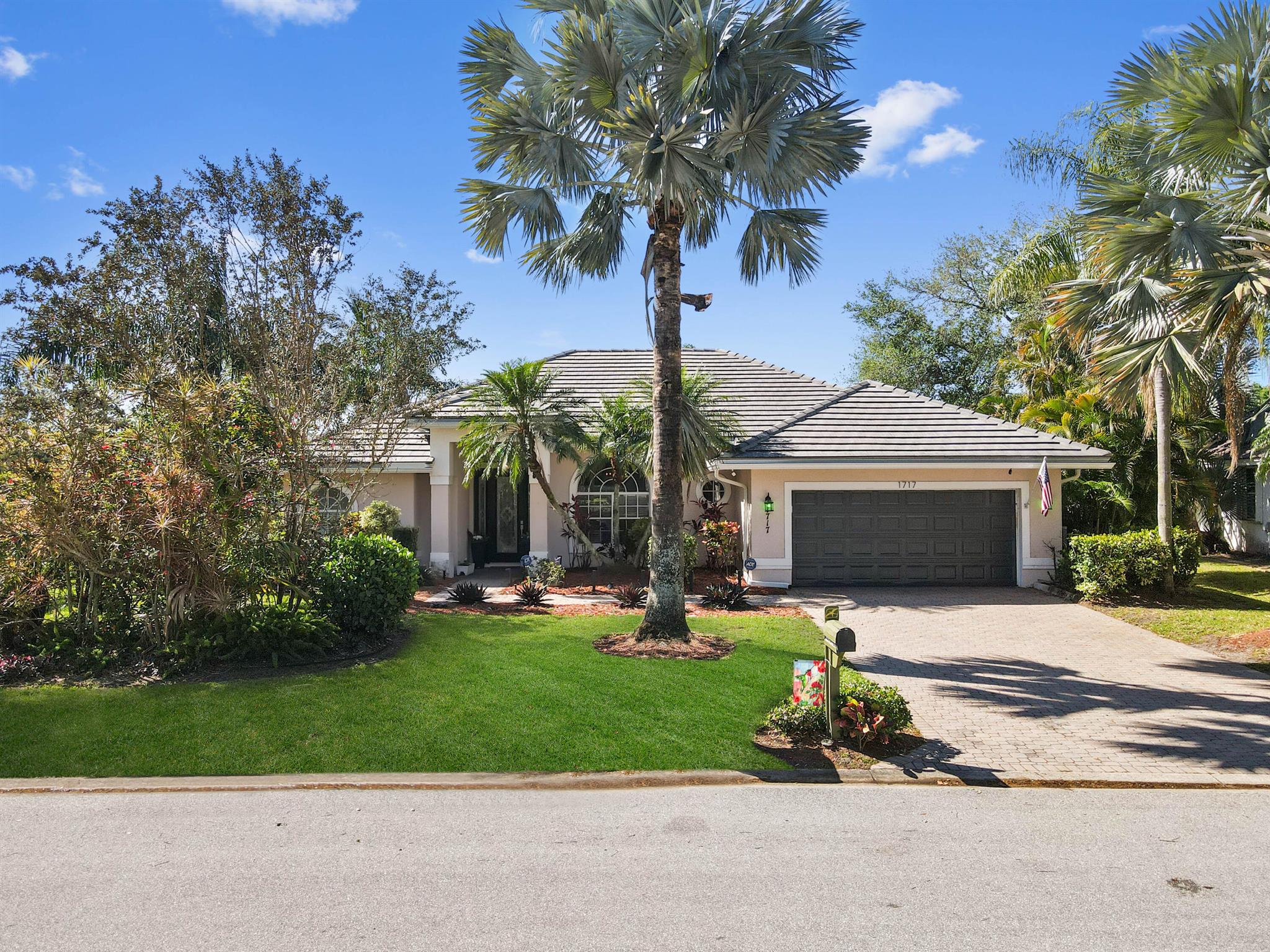 Discover waterfront living at its finest in Country Club Estates! This beautiful 1-story home offers 1,847 sqft of well-designed space with breathtaking lake views and a relaxing screened pool. Featuring 3 bedrooms, 2 bathrooms, and a 2-car attached garage, this home is designed for comfort and convenience.A charming French main door with daylight panels welcomes you into a bright foyer, leading to an entry-level living area and an elegant dining space. The kitchen boasts a bar with appliances, ample cabinet storage, and tile flooring throughout. A dedicated laundry room includes a tub, washer, and dryer for added convenience.Step outside to the screened pool and patio, perfect for enjoying the serene lake views and outdoor entertaining.