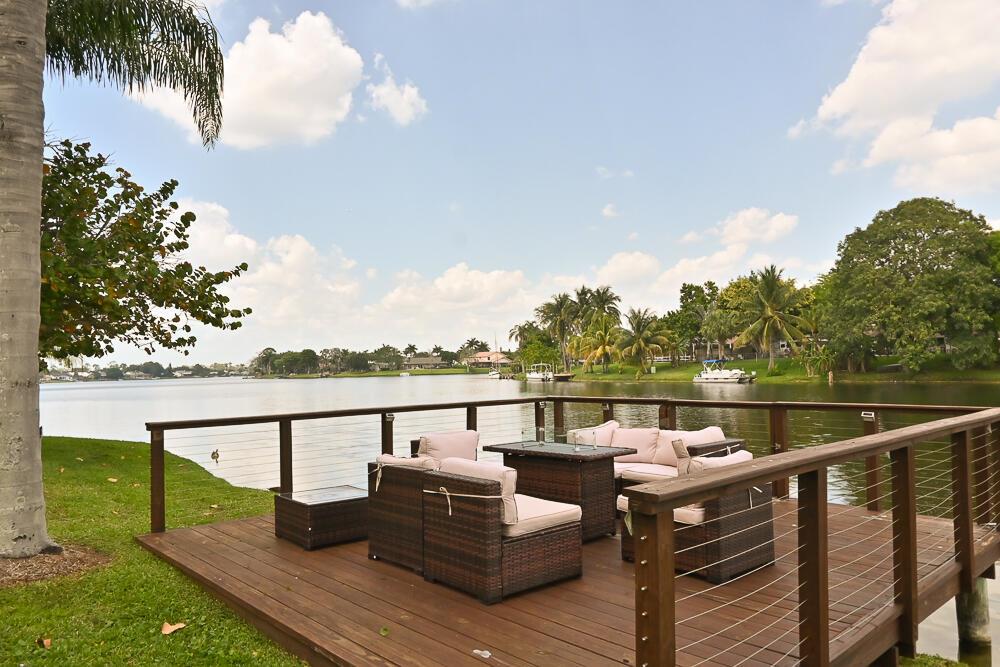 Seasonal Rental. Enjoy the Season in this beautiful residence, which is directly waterfront on Lake Wellington!! The two-story home has been designed with a large custom screened patio, a new dock, and lots of landscaping to create an exceptional living environment with gorgeous lake views and unlimited sunrises! Fully Furnished. The primary bedroom is conveniently on the first floor. The home is equipped with Accordion shutters. The community has a heated pool and clubhouse.