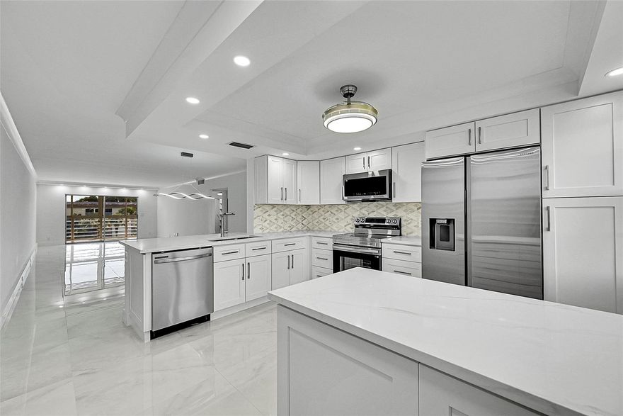 SPACIOUS & MODERN CORNER 2BED/2BATH CONDO WITH GOLF AND POOL VIEWS! BEAUTIFULLY REMODELED WITH NEW PORCELAIN FLOORS THROUGHOUT, OPEN KITCHEN CONCEPT WITH QUARTZ COUNTERTOPS, NEW STAINLESS STEEL APPLIANCES, AND MODERN CABINETS. BOTH BATHROOMS ARE COMPLETELY UPDATED WITH CONTEMPORARY SHOWERS AND FINISHES. ENJOY WALK-IN CLOSETS WITH CUSTOM BUILT-INS AND CEILING FANS IN EVERY ROOM. THIS BRIGHT, AIRY, AND LARGE CONDO IS LOCATED IN ONE OF THE TOP VILLAGES IN WYNMOOR—JUST A SHORT WALK TO THE TENNIS COURTS AND CLUBHOUSE. MOVE-IN READY AND PERFECT FOR THOSE SEEKING A STYLISH, ACTIVE LIFESTYLE IN A RESORT-STYLE COMMUNITY!. ASSOC REQUIRES 20% DOWN & 1 OCCUP 55+