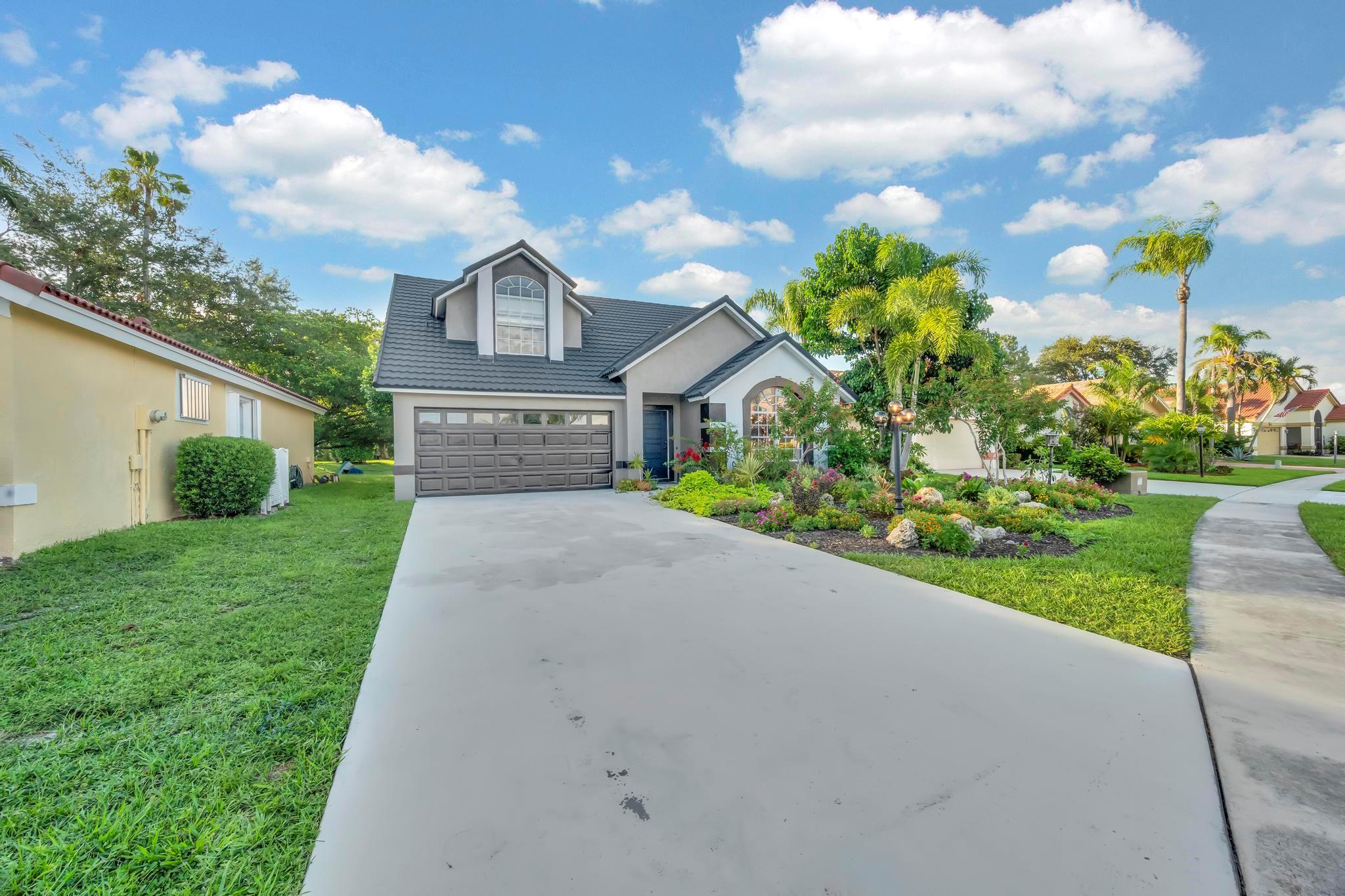 Welcome to this beautiful 3-bedroom, 2.5-bathroom waterfront pool home in the charming community of Lake Point, just minutes from the Wellington Equestrian Centre, local parks, and A-rated schools. Freshly painted inside and out, the home opens to a formal living and dining area with vaulted ceilings and neutral flooring that create a warm, welcoming feel. The spacious family room is perfect for cozy evenings, while the updated kitchen, featuring Turkish travertine tile backsplash and granite countertops, is a true chef's delight.The primary suite is a peaceful retreat with a vaulted ceiling, walk-in closet, custom chandelier, and a soaking tub ideal for winding down after a long day.